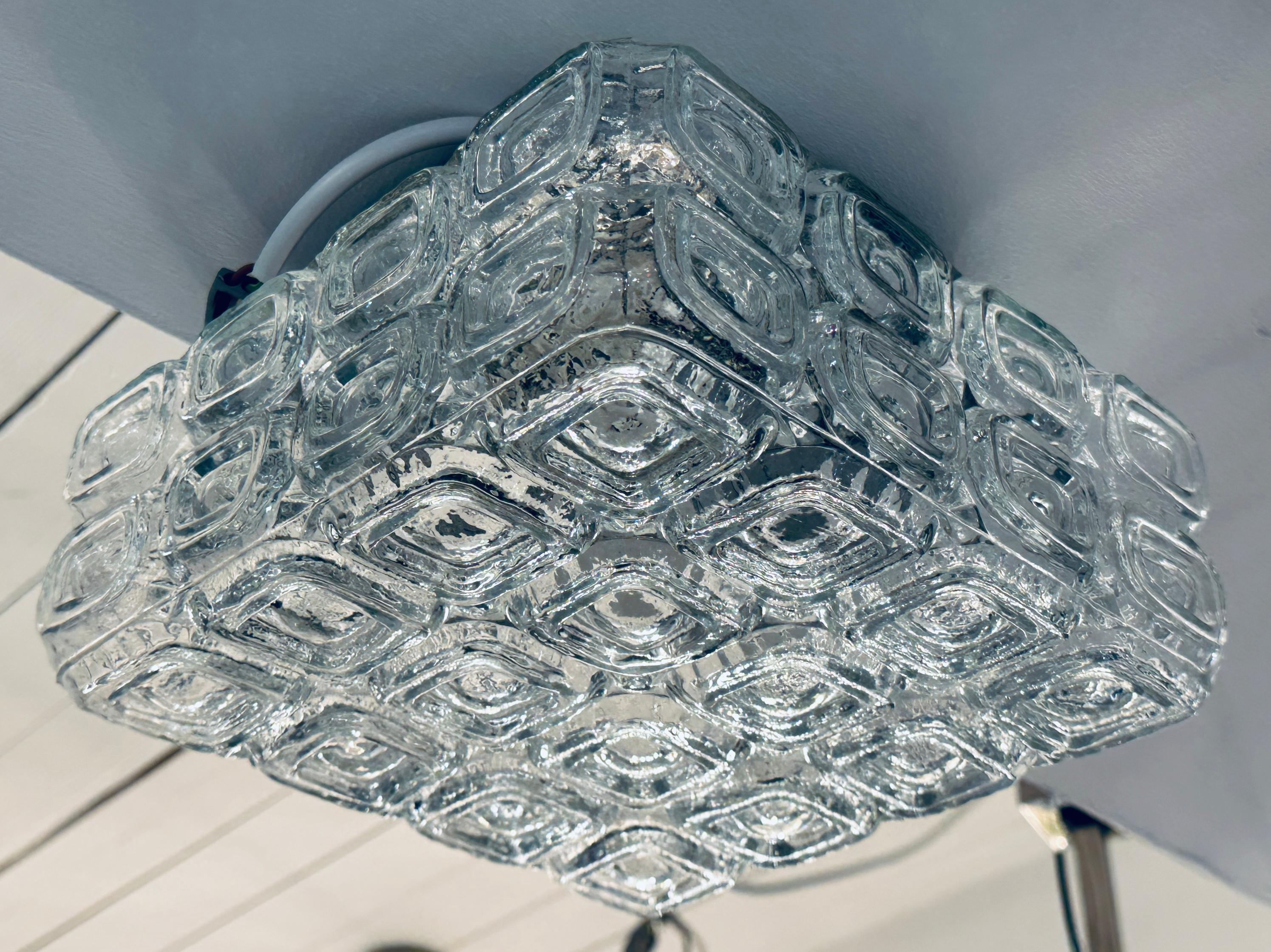 1960s vintage German WILA square clear glass shade and metal flush mount ceiling or wall light.  The square shade is fixed to the round black metal bulb holder with a single screw holding it in place.  The design features 4 x 4 geometric squares