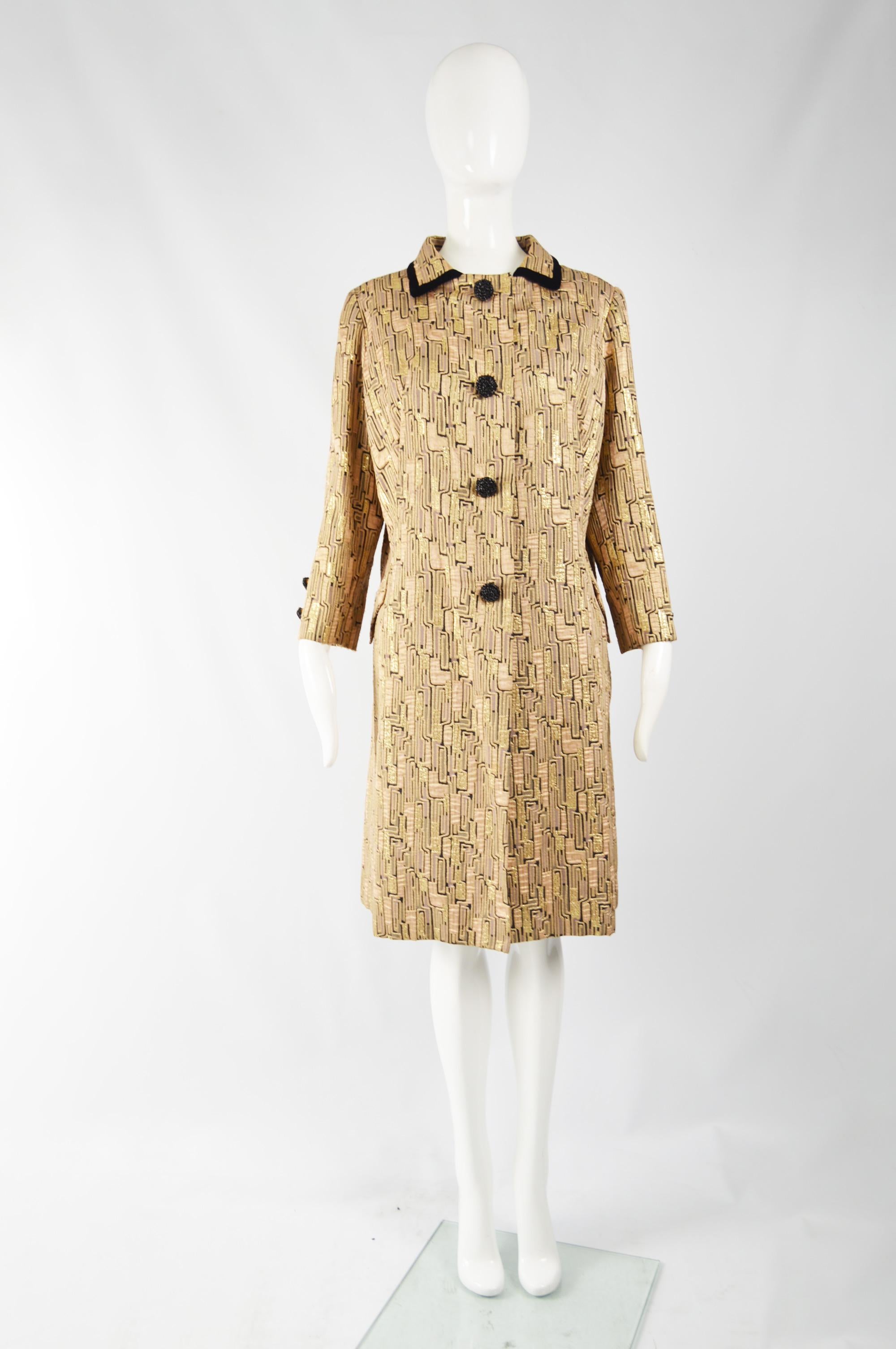 A fabulous vintage evening coat from the 60s by Violet Yorke. The fabric is a metallic bronze and gold brocade with a velvet trimmed collar. It has beaded buttons and a loose, swing fit.  

Size: Unlabelled; meant to have a large, swing fit so would
