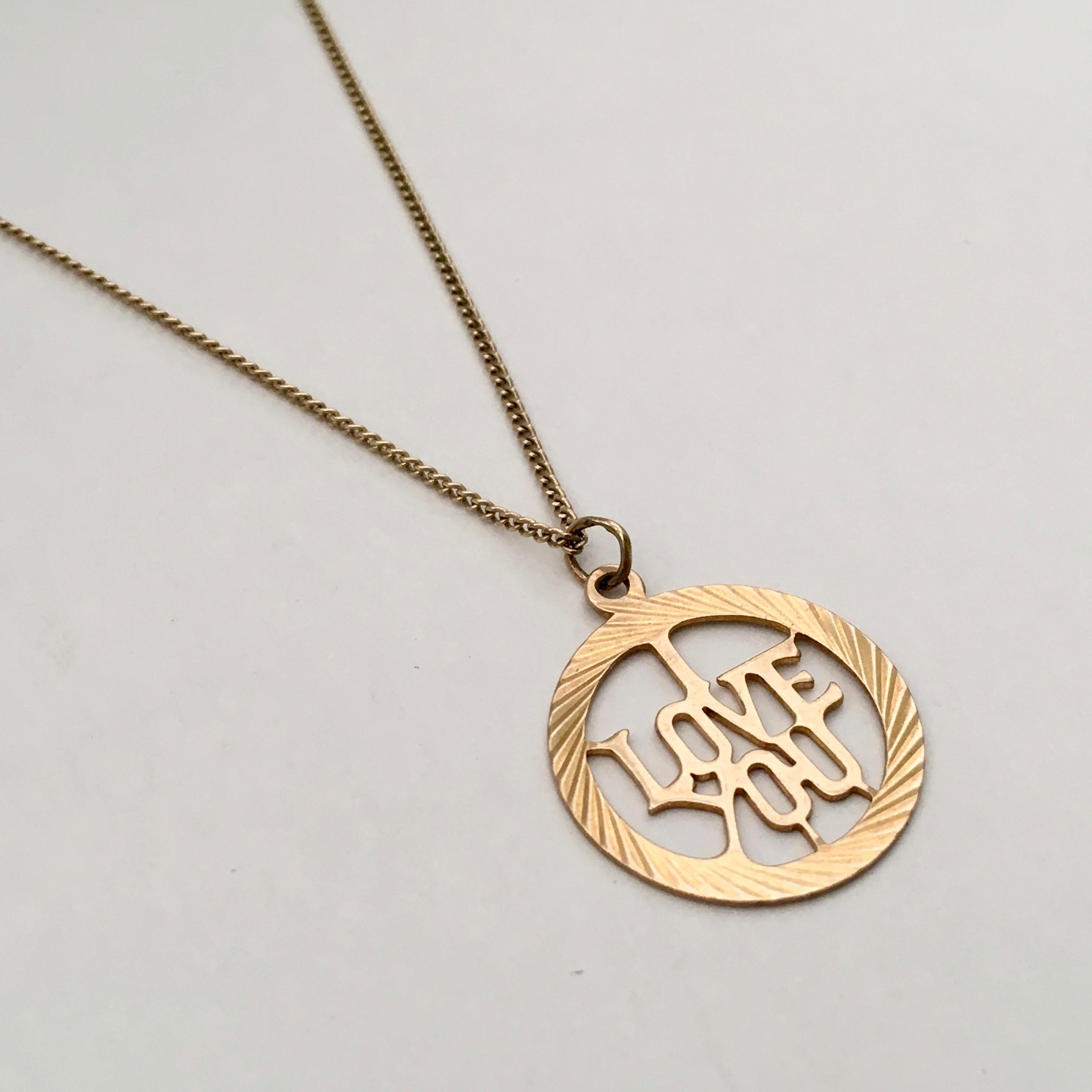 This stylish vintage charm has a whimsical air. The central 'I love you' pierce lettering sits within an engine-turned circular surround. Full hallmarks date the piece to 1969 and tell us that is was assayed in London. A makers mark of 'GJ Ltd' is
