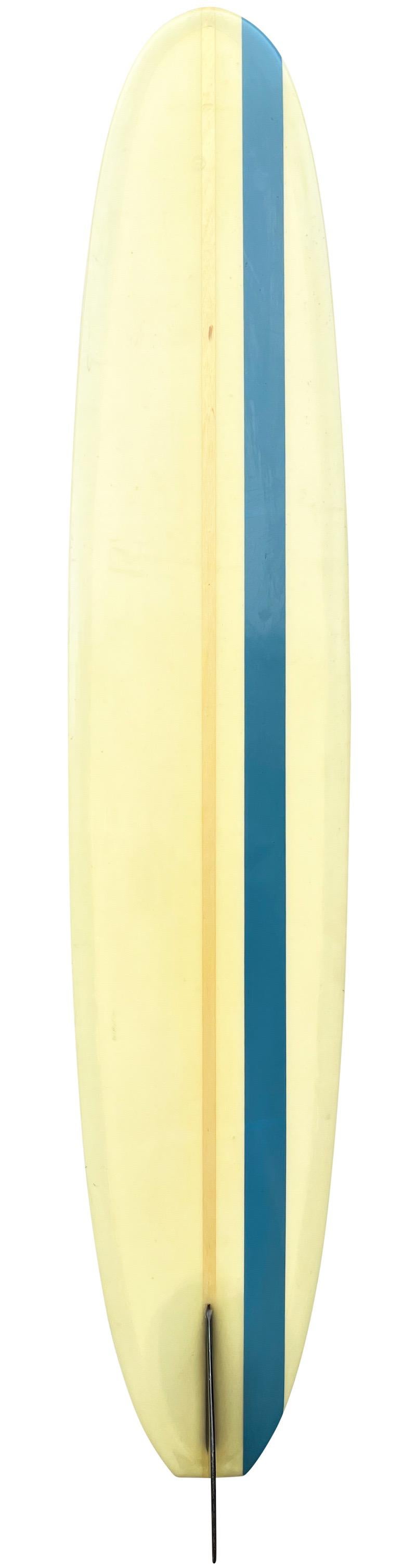 Early-1960s Gordie surfboards longboard “The Only Way to Travel”. Features a Classic 60s longboard shape with vibrant blue stripes and fixed black single fin. A superb example of a well cared for all original longboard made in the 1960s.