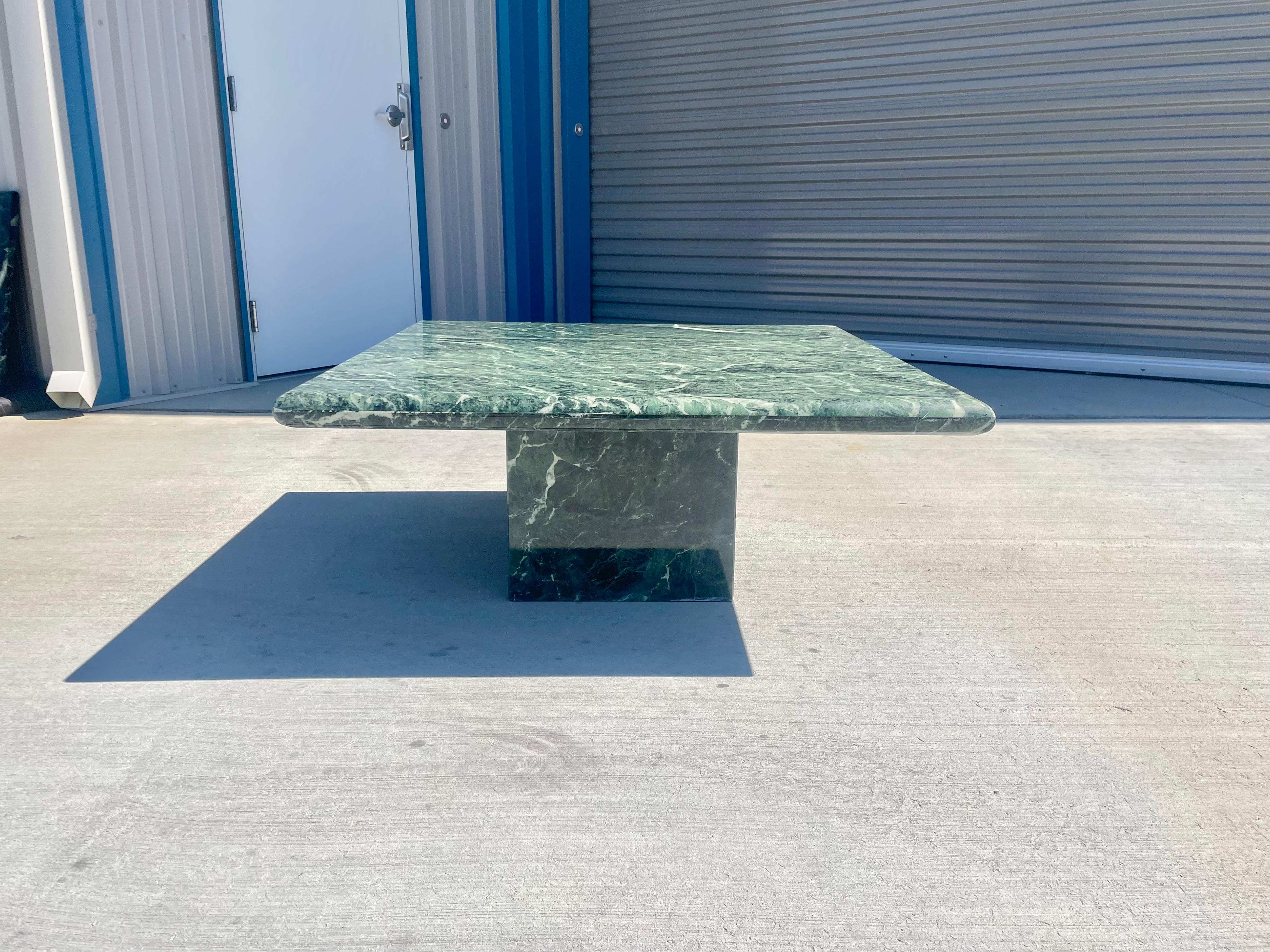 Vintage emerald coffee table designed and manufactured in Italy circa 1970s. This beautiful coffee table is made of breccio marble, giving it that eye-popping look everyone wants in their home. The table features a gorgeous cantilevered marble top