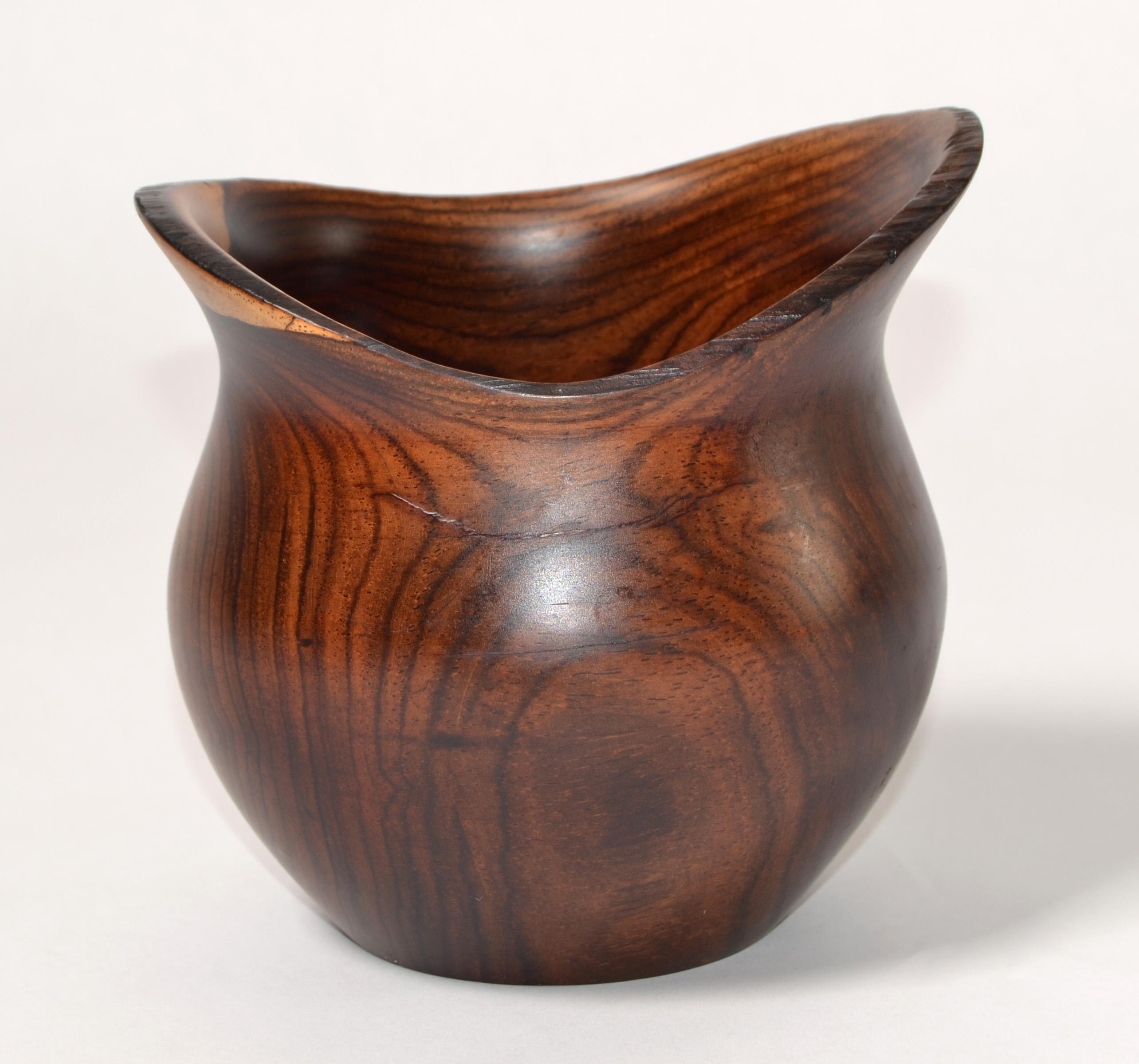 Vintage Arts and Crafts Period, circa 1960s Cockhill Crafts Style midcentury modern design bud vase. It is hand turned in Yew wood of simple subtle cured form, emphasized by the contrasting Colors and grain of the wood. 
This lovely stylish piece