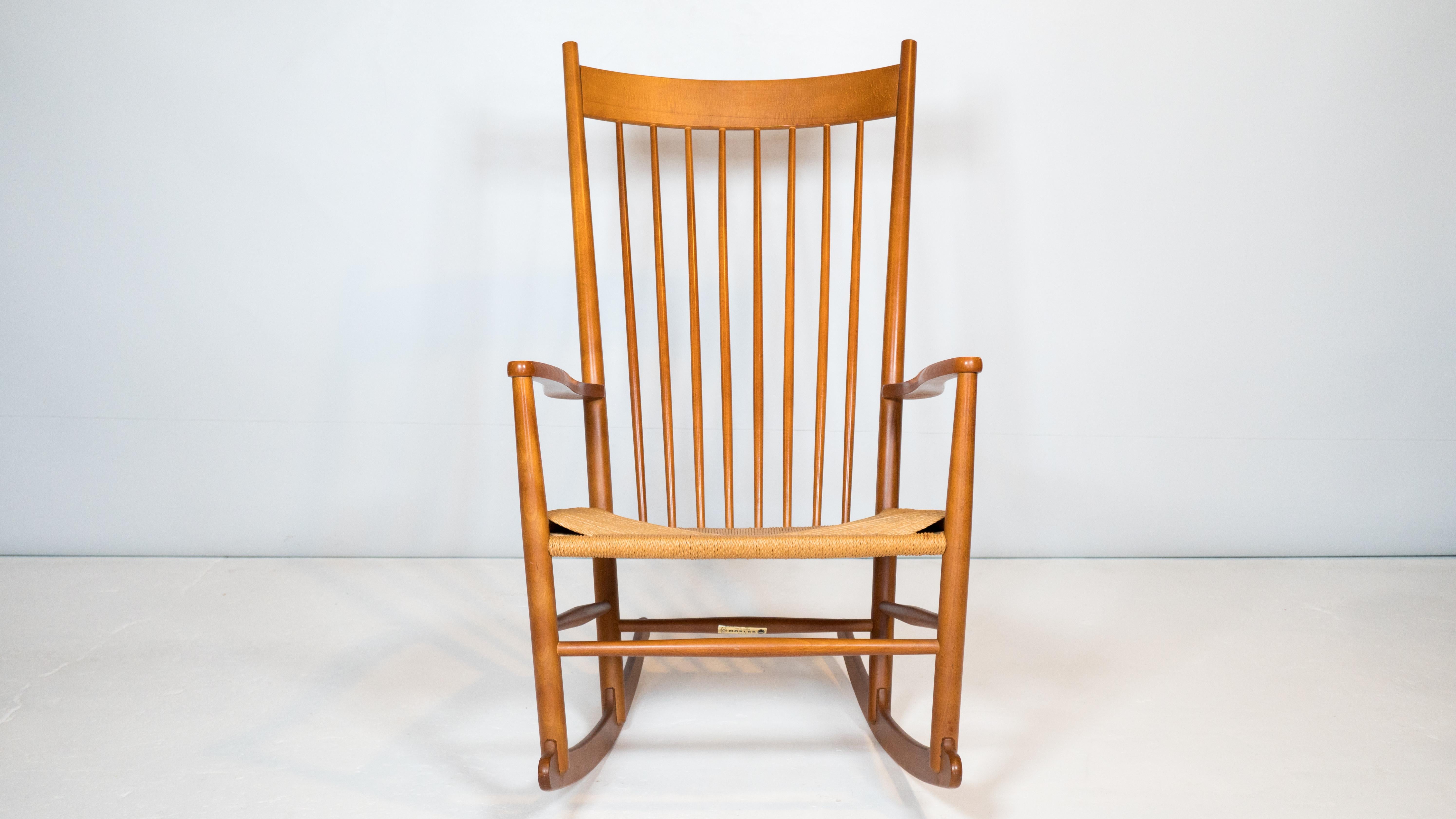 Mid Century Danish Modern 'Model J16' rocking chair by Hans Wegner for FDB Møbler, circa 1970s. Solid lacquered beech wood frame with woven paper cord seat. Great lines and craftsmanship. Great vintage condition. Manufacturer label present. Made in