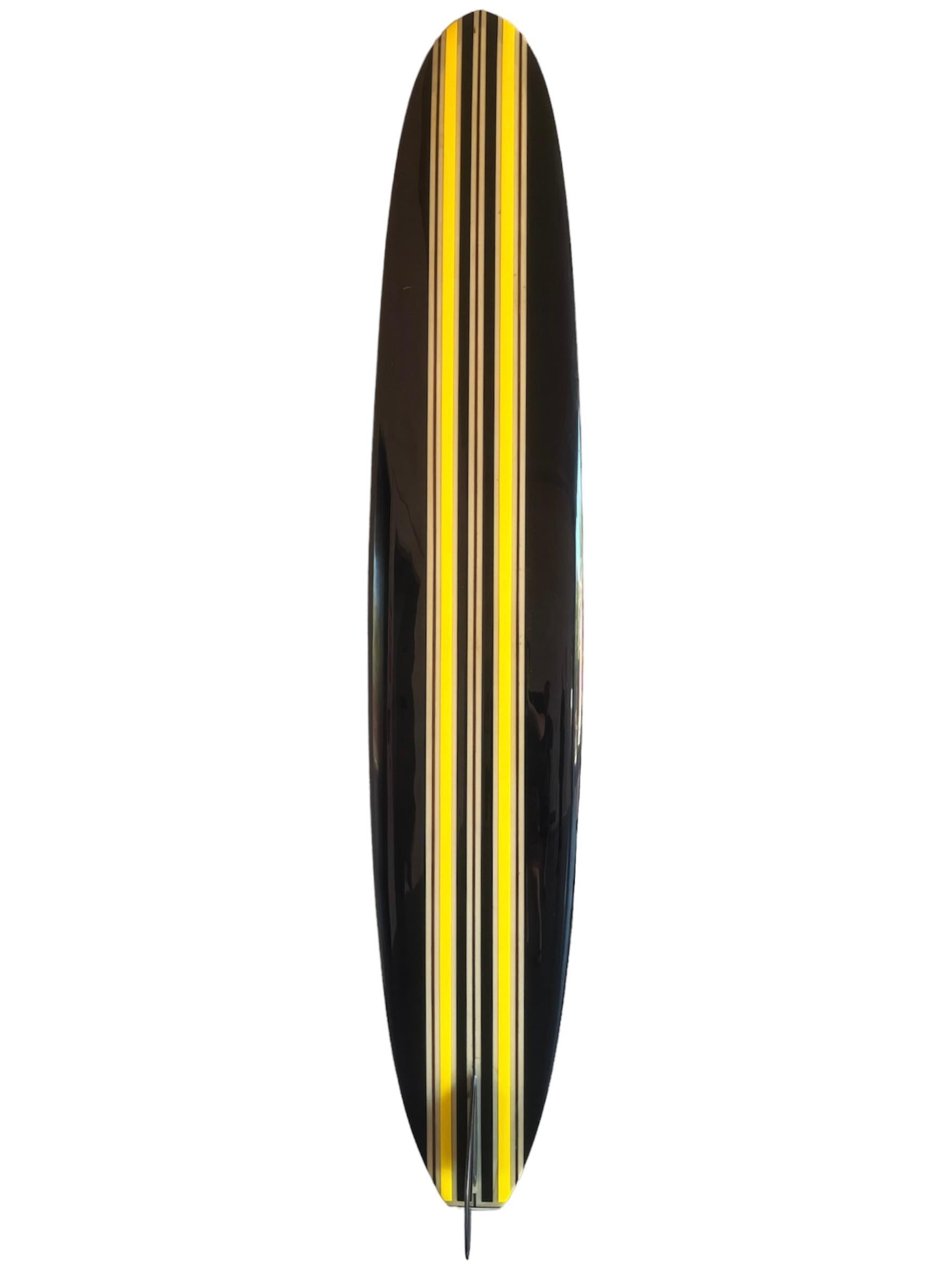 Vintage 1960s Hansen classic longboard. Features sleek black rails with alternating yellow & black stripes. 3 redwood stringers with square tail. A remarkable example of a mid-1960s classic longboard shaped under the revered Hansen Surfboards label. 