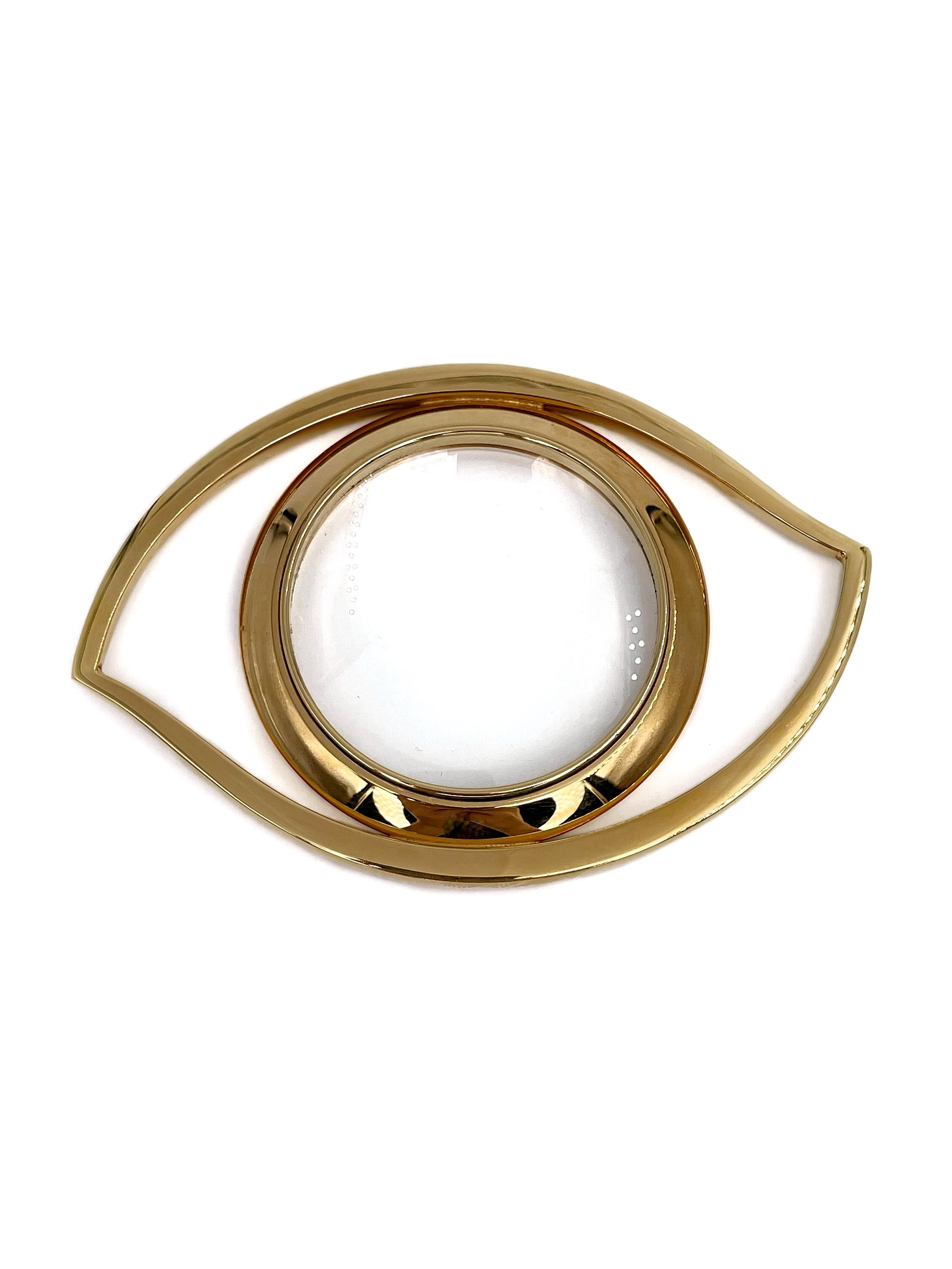 This is a desk magnifying glass designed by Jean Cocteau for Hermes in 1960’s. It represents the Eye of Cleopatra in gilded metal. It can be used as an interior detail or also worn as a massive pendant or scarf ring. 

Signed: “Hermès. Paris” (shown