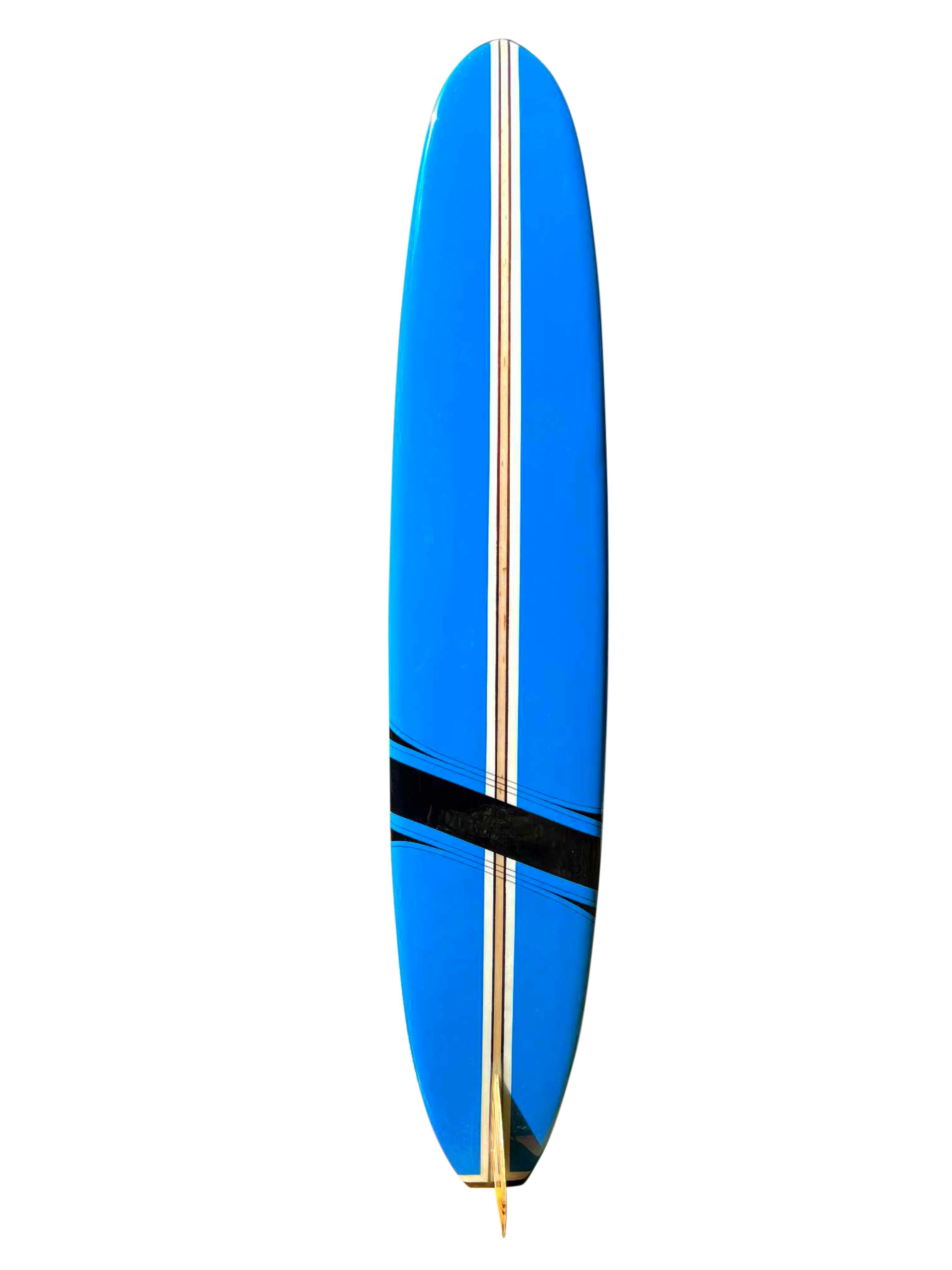 Early-1960s Hobie competition longboard surfboard. Features beautiful blue panels with jet-black competition band and matching pinstriping. Intricate 17 piece wooden fin with wide square-tail. A gorgeous example of a competition Hobie longboard