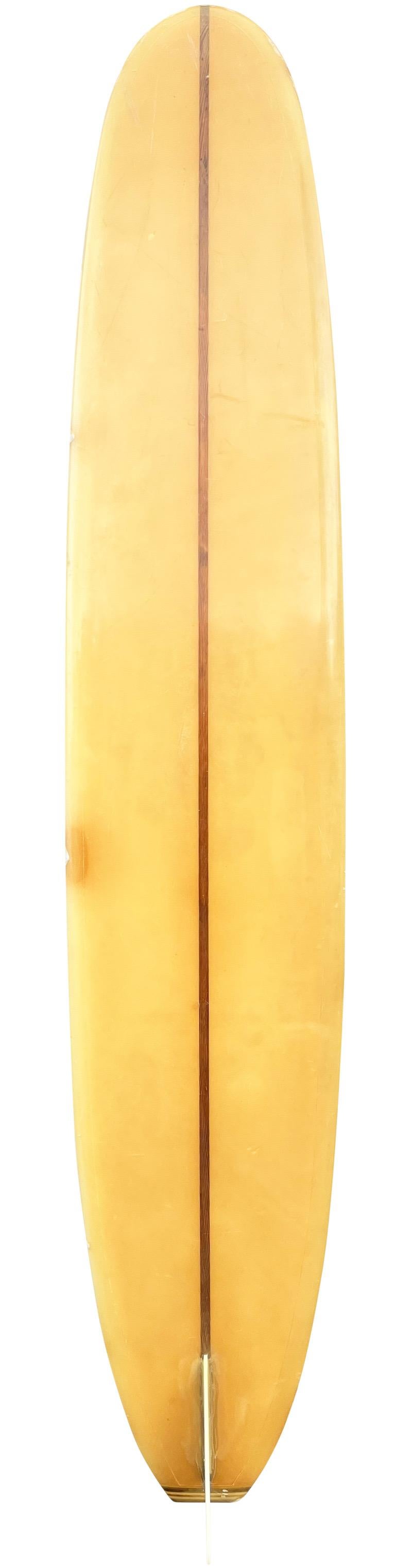 Mid-1960s Hobie Surfboards longboard. Features beautiful red panels with redwood stringer and fixed single fin. A gorgeous example of an all original classic 1960s longboard shaped under the iconic Hobie Surfboards label.