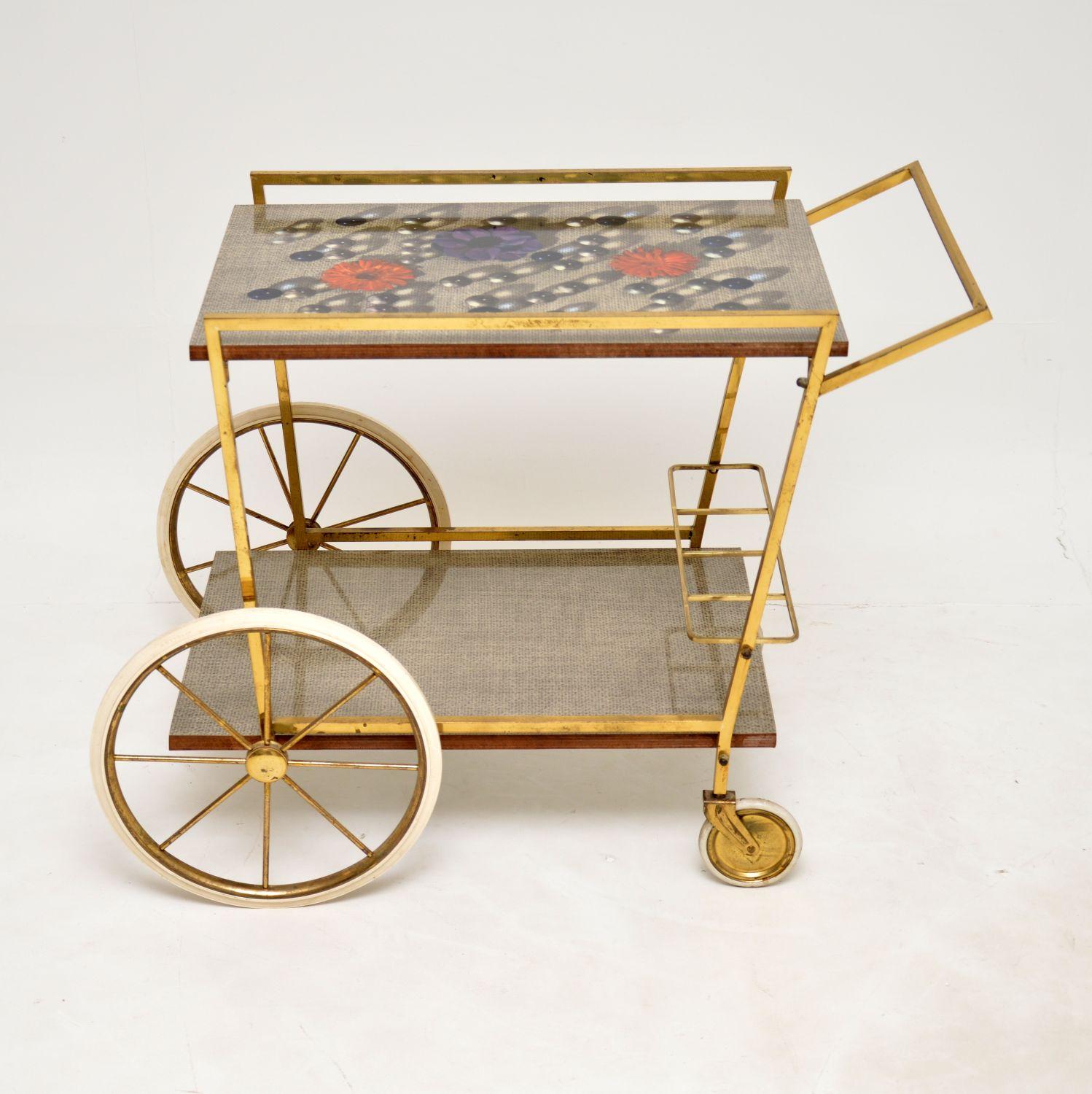 A stunning vintage drinks trolley in solid brass and Formica. This was made in Italy, it dates from the 1960’s.

It has a gorgeous, angular design and is a lovely size. The Formica tops are a beautiful addition, and are reminiscent of