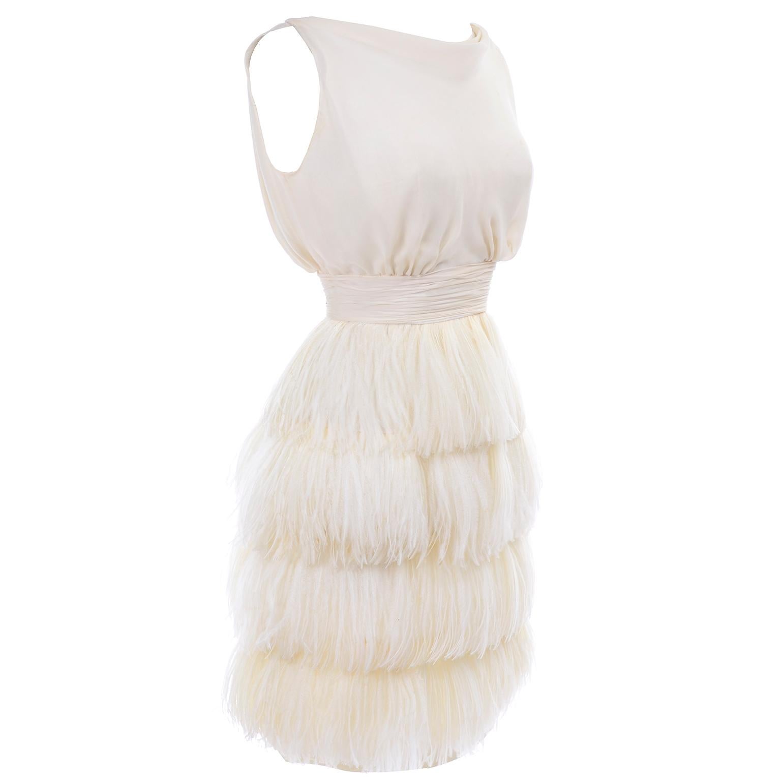 This is a gorgeous vintage dress from the 1960's in a creamy ivory silk with wonderful ostrich feather plumes.  We acquired this dress from the wife of a prominent political figure and businessman in Oregon. Her wardrobe included many early pieces