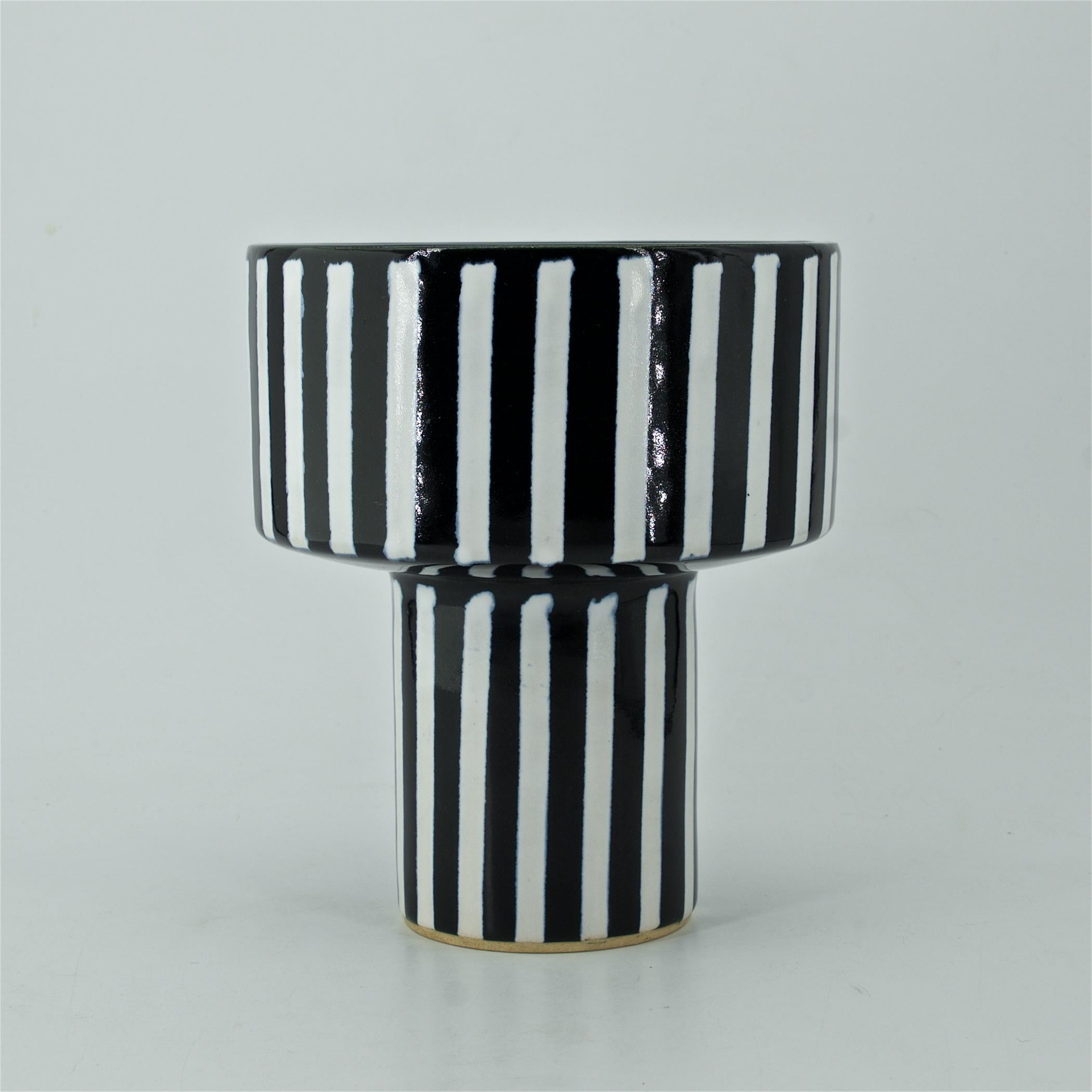Very clean, appears unused, black and white stripes, planter on narrow pedestal.