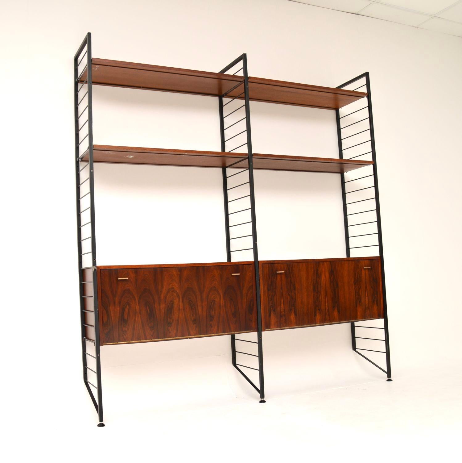A stylish and very rare vintage ladderax wall unit in wood. This was made by Staples in England, it dates from the 1960’s.

It is very unusual to find these in wood, they are much more commonly seen in teak. The three rails lean against the wall
