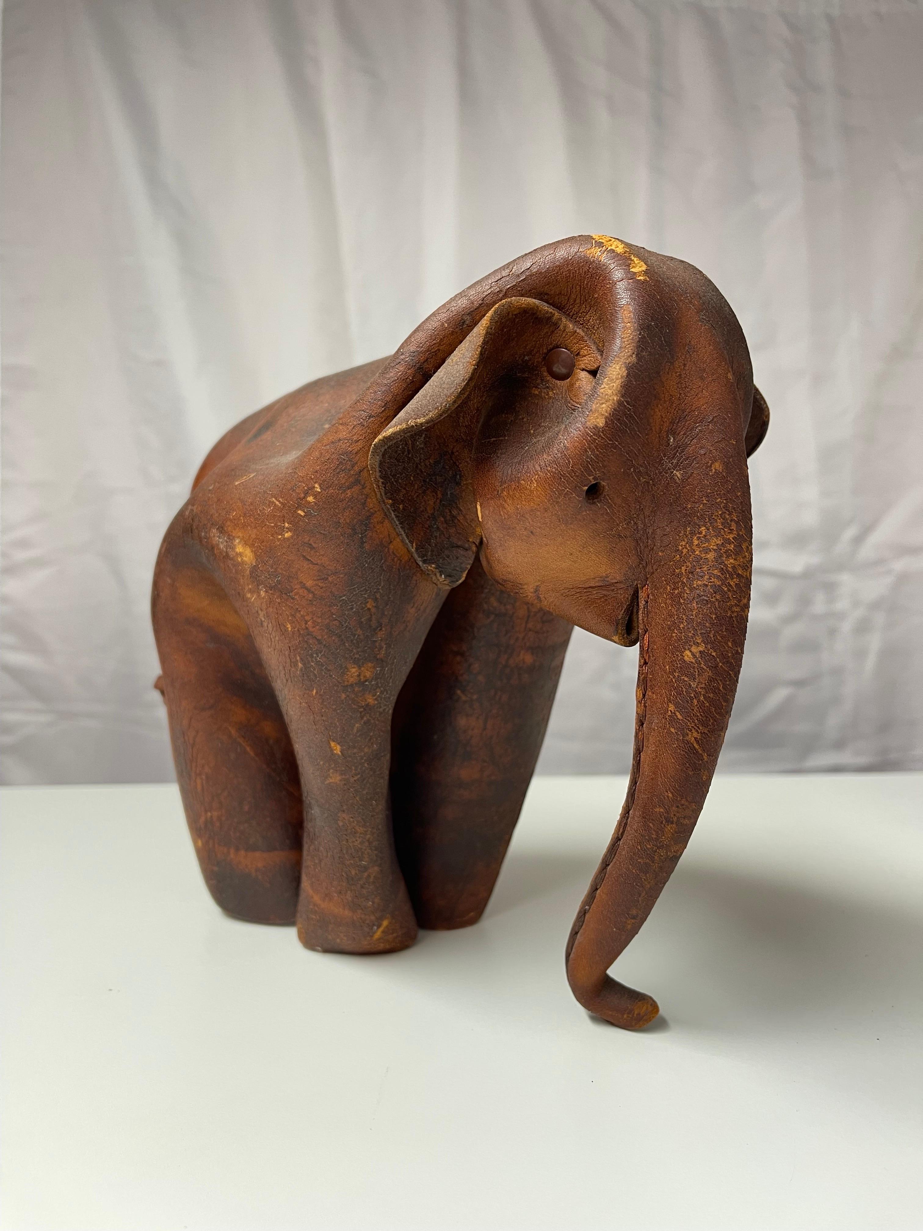 1960s Vintage Leather Deru Elephant . Designed and produced by the German manufacturer DERU in Wiesbaden in the 1960s.  This leather origami elephant is folded from a single piece of leather and cleverly shaped and sewn into an irresistible