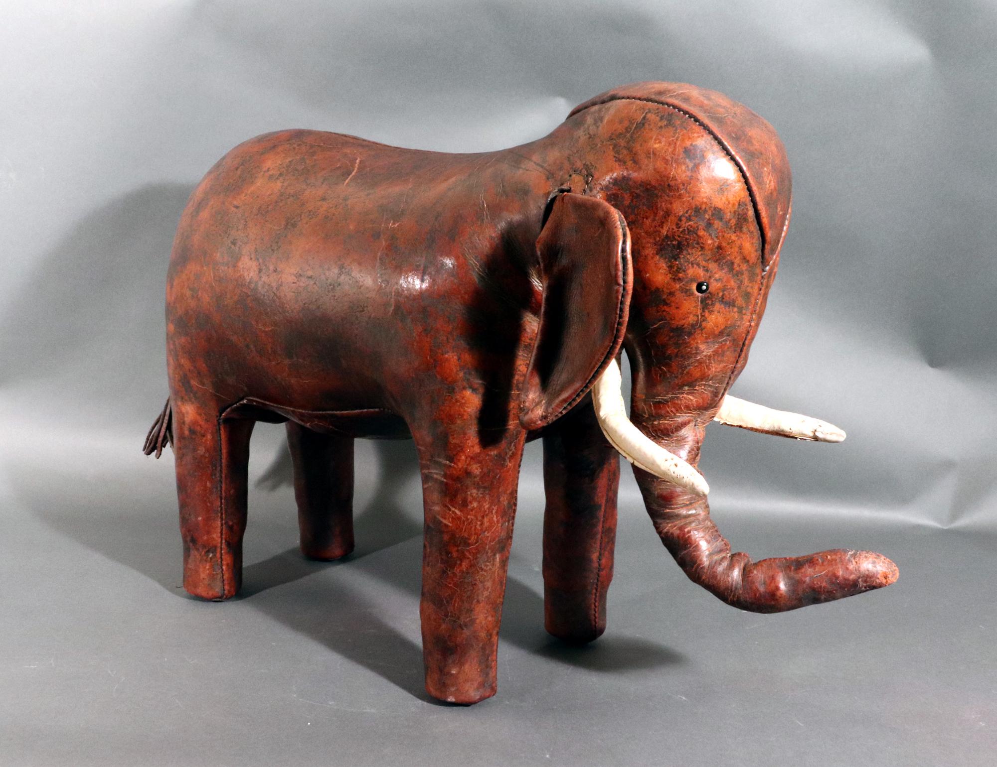 Vintage Leather Elephant Stool or Ottoman,
Dmitri Omersa,
1960s

The leather footstool is designed in the shape of an elephant in a beautiful leather.  The tusks are white leather and the body a brown.  The condition is excellent with typical patina