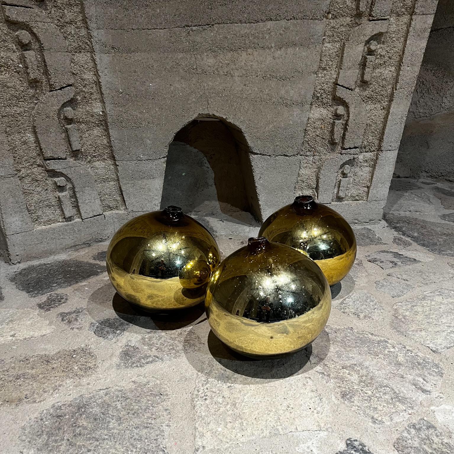 Vintage 1960s Mexico Mercury Glass Three Gold Globes Gazing Ball Spheres
10 tall x Biggest 10 diameter Smaller 9.5 diameter
Set of 3 mercury glass spheres. 
Crafted in Handblown glass.
No stamp or label present from the maker.
Inspired by