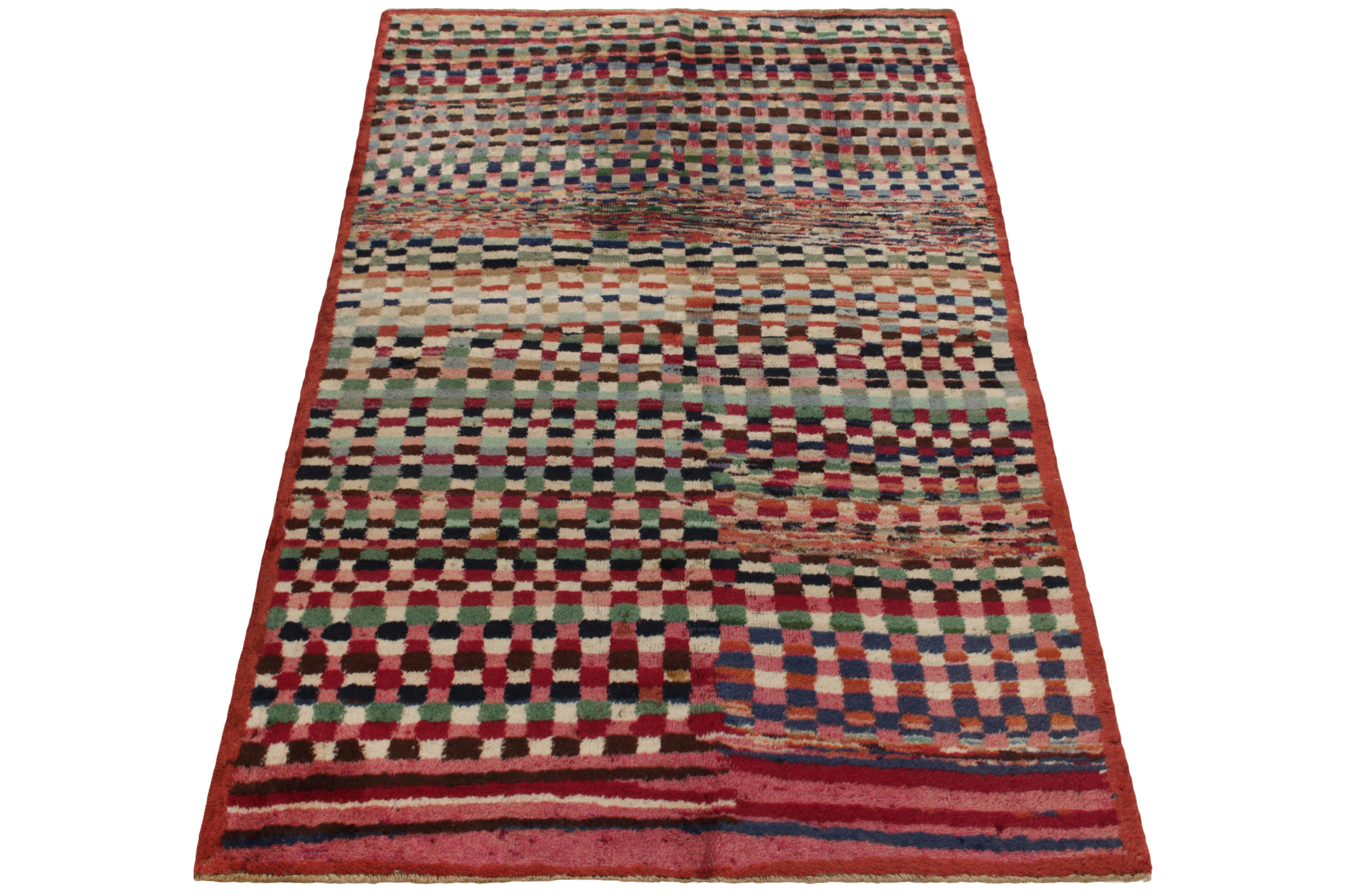 Hand-knotted in wool, a 4x6 vintage rug from a bold Turkish designer, commemorated in Rug & Kilim’s Mid-Century Pasha Collection. Featuring a repetitive geometric pattern in variegated mature tones, the rug reads dextrous juxtaposition in bright red