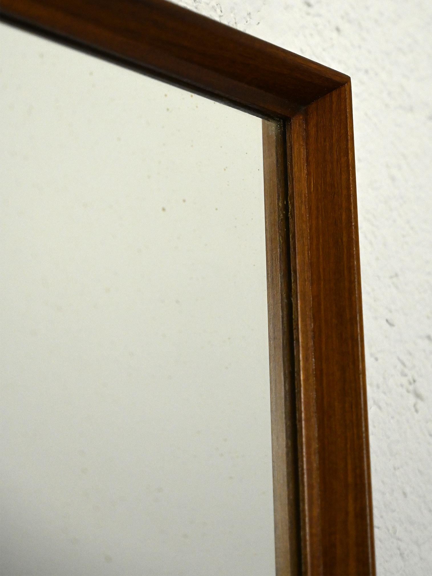 Scandinavian teak wood mirror.

Featuring an understated and modern design, this teak wood mirror features clean, minimalist lines. Its square, rectangular shape makes it ideal as a wall mirror, perfect for enhancing the entryway or bedroom. The