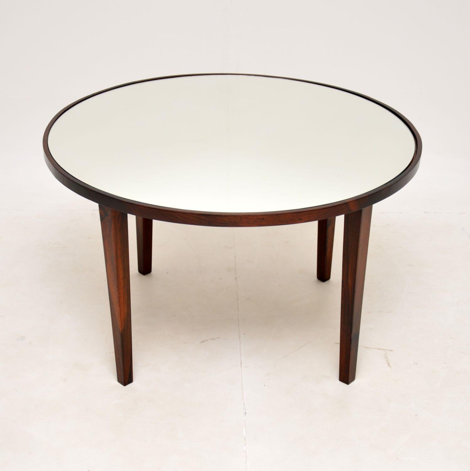 A very stylish and well made vintage coffee table. This was made in Brazil, it dates from the 1960’s.

It is of superb quality, with lovely grain patterns and an inset mirrored glass top.

We have had the frame stripped and re-polished to a very