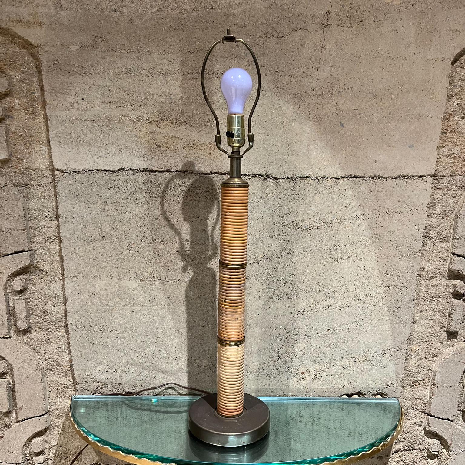 Vintage Wrapped Cane and Brass plated Table Lamp.
24.25 to socket x 7 diameter
No lamp shade is included. 
Preowned original vintage unrestored condition
See all images provided.
