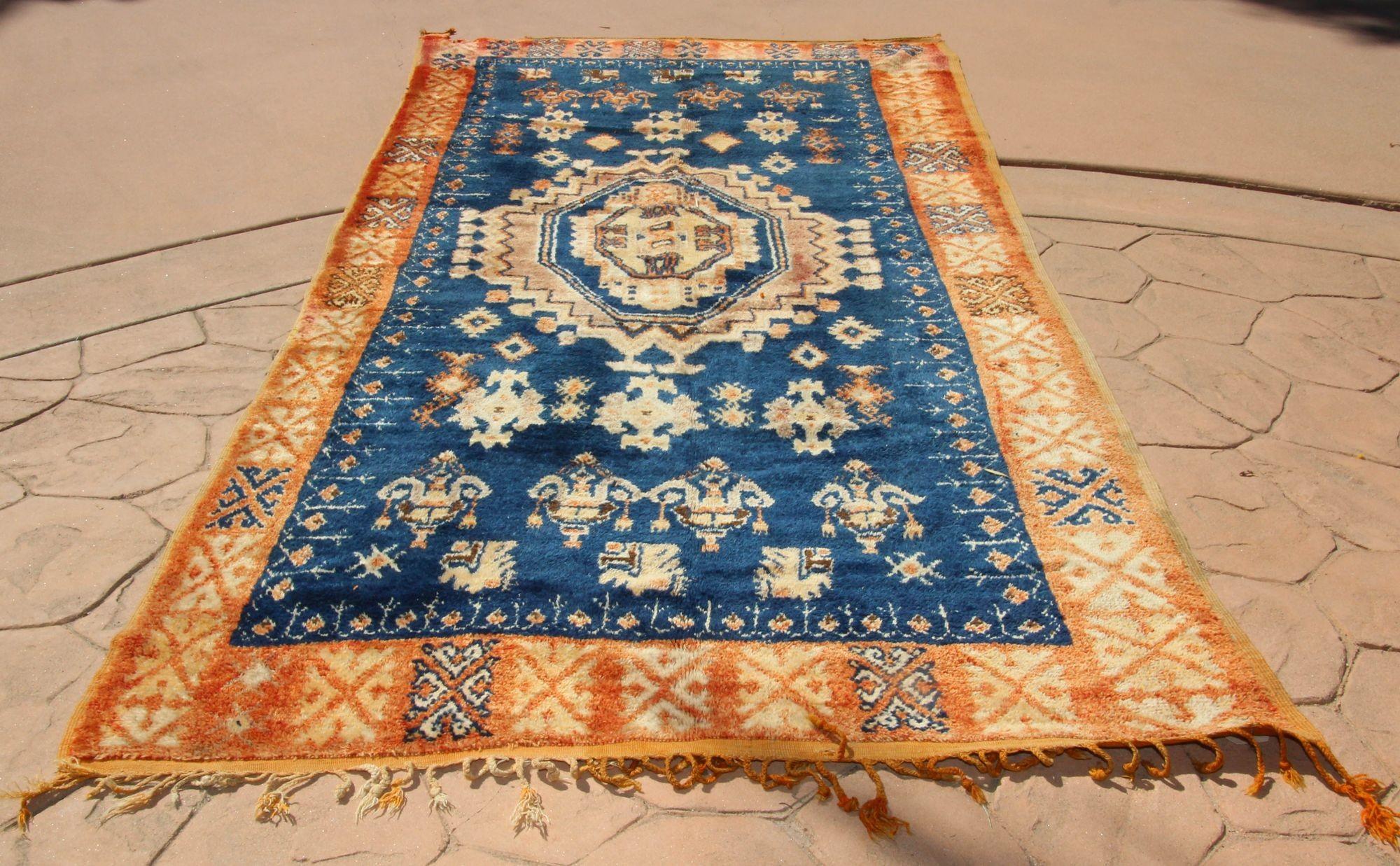 1960s Vintage Moroccan Tribal African Rug in Indigo and Burnt Orange cors.Authentic 1960s vintage Moroccan tribal African rug.For centuries the tribal people of Morocco's Atlas Mountains have passed down the delicate art of rug-weaving. In Northern