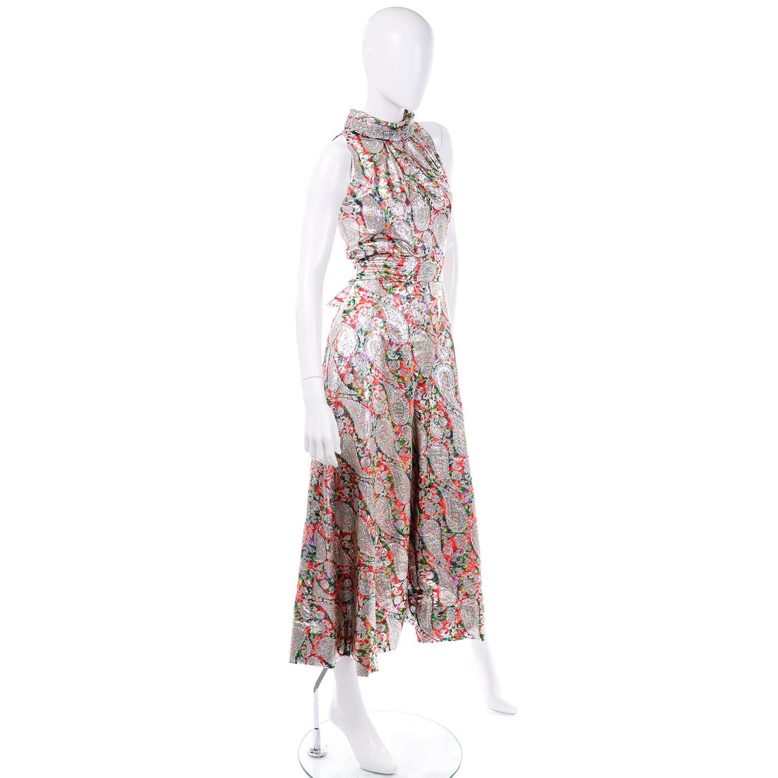 This is a fabulous and festive jumpsuit for the holidays as it would make a great evening dress alternative!! We love the rainbow and silver tone lamé paisley detailing throughout this silhouette. The colors of this jumpsuit include: silver, red,