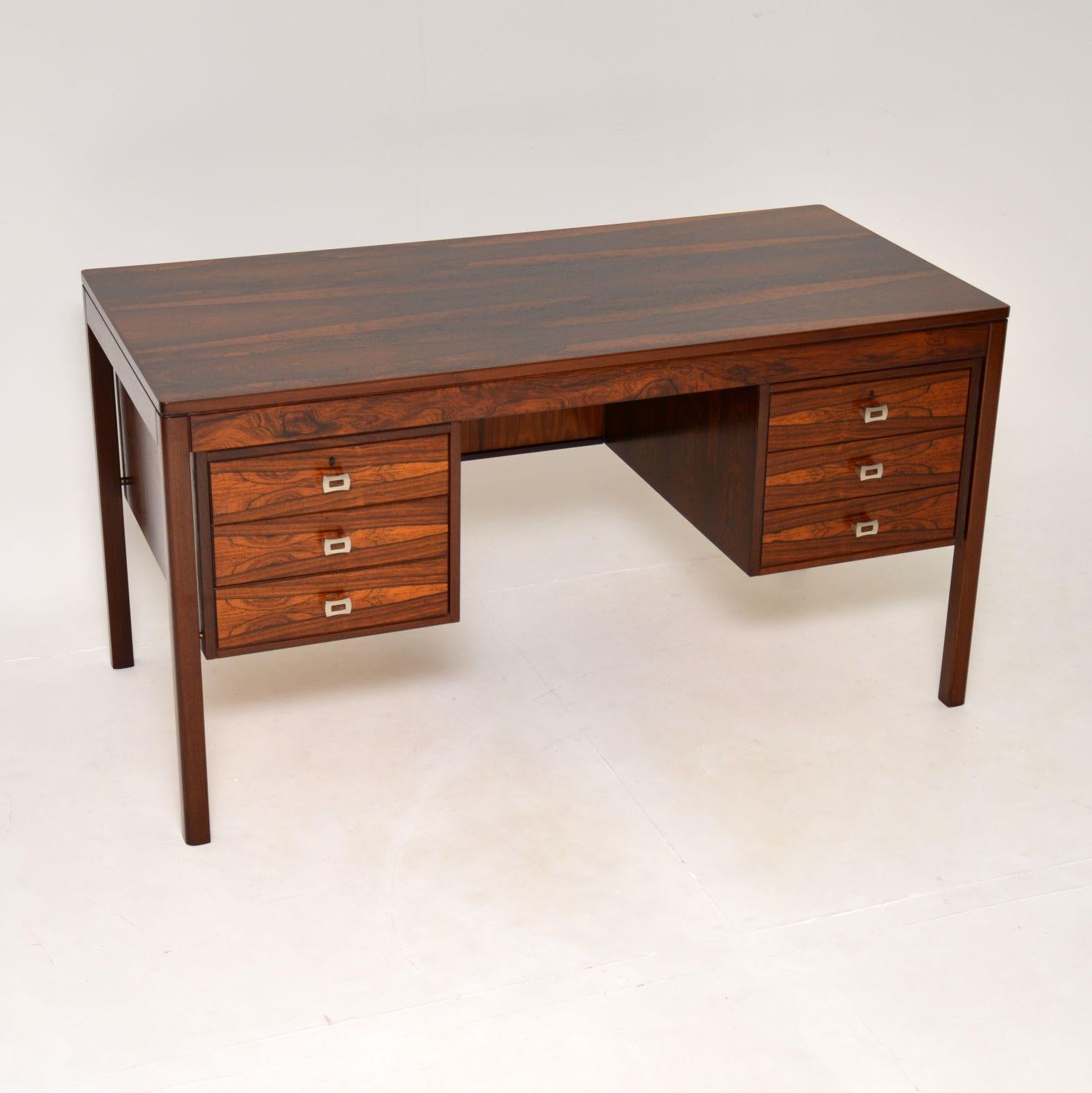 A stunning vintage Scandinavian designer desk, beautifully made from wood. This was designed by Torbjorn Afdal for Bruksbo, it was made in Norway and dates from the 1960’s.

The wood grain patterns are incredible on every part of this, and it has