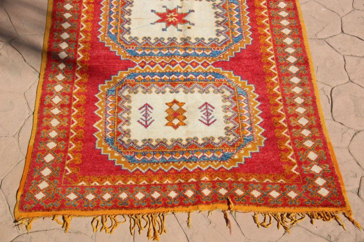 Tapis berbère authentique marocain des années 1960, orange, bleu et rose.Depuis des siècles, les populations tribales de l'Atlas marocain ont transmis l'art délicat du tissage de tapis. En Afrique du Nord, les tapis ne sont pas seulement un atout