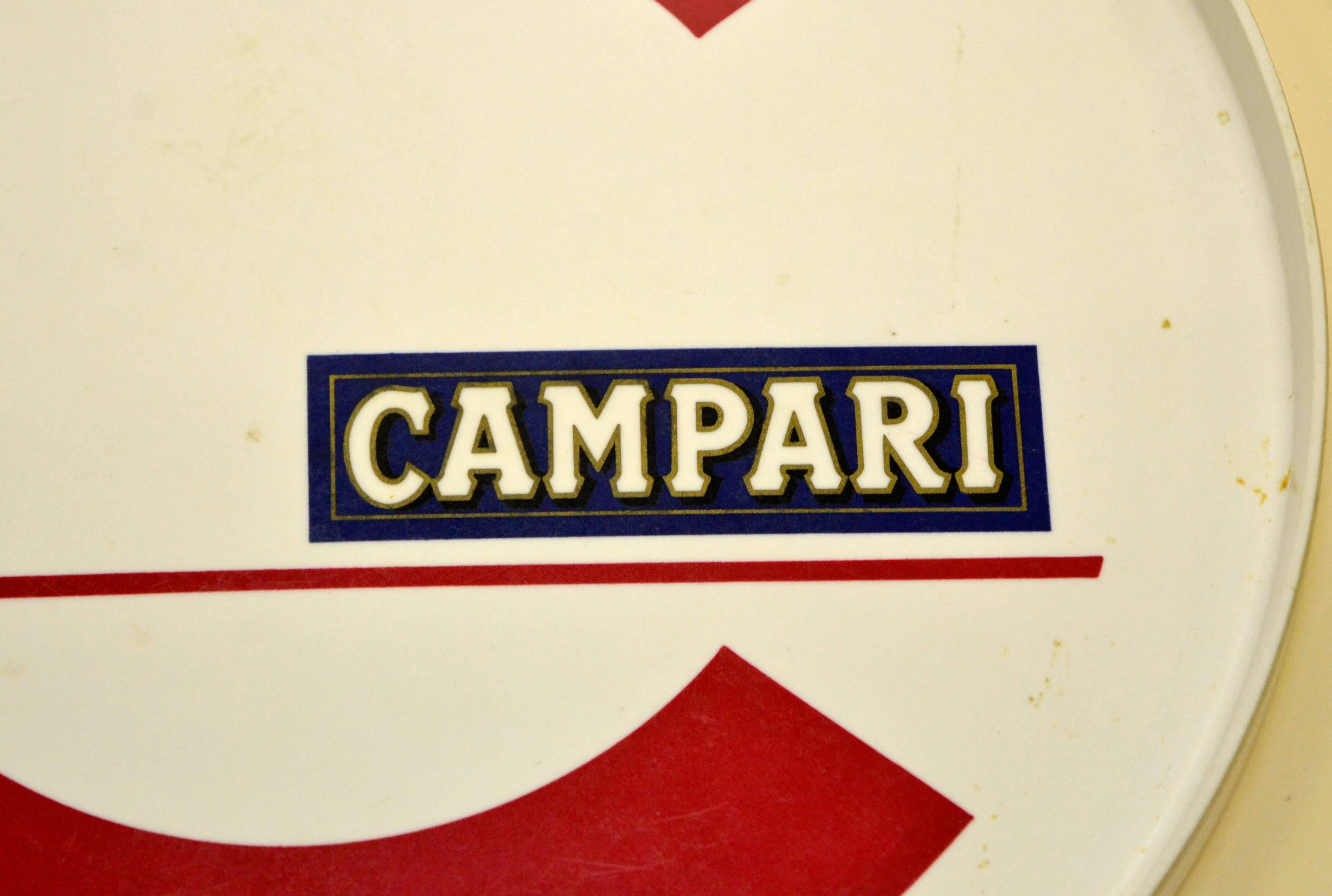 Vintage blue, red and white plastic round bar tray made in Italy by Galessi Pubblicità Milano for Campari. 

Collector's note:

Campari is an Italian alcoholic liqueur, considered an apéritif obtained from the infusion of herbs and fruit in