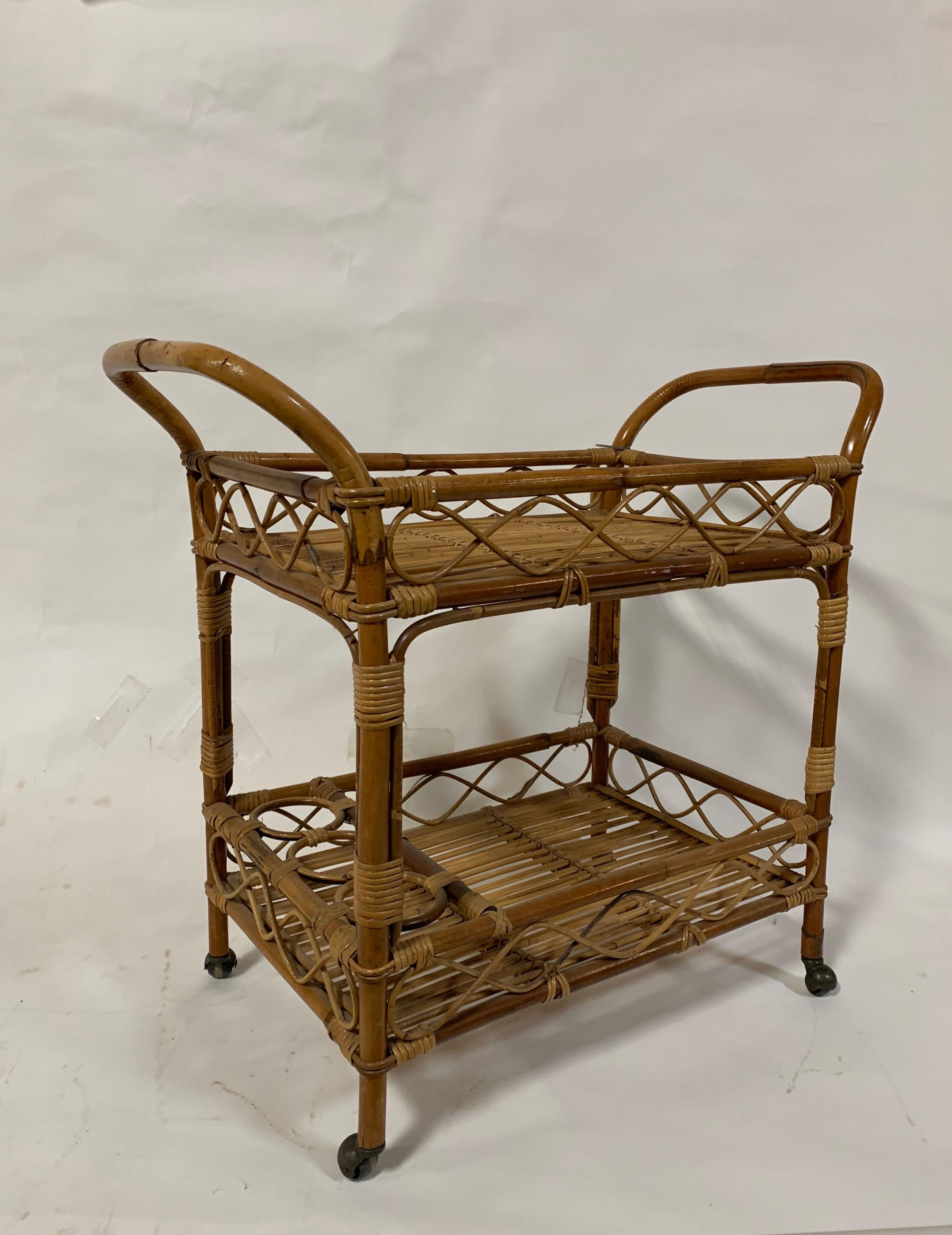 Vintage rattan bar cart with second lower shelf, bottle holders and casters, USA, circa 1960. 

Dimensions: 34.5