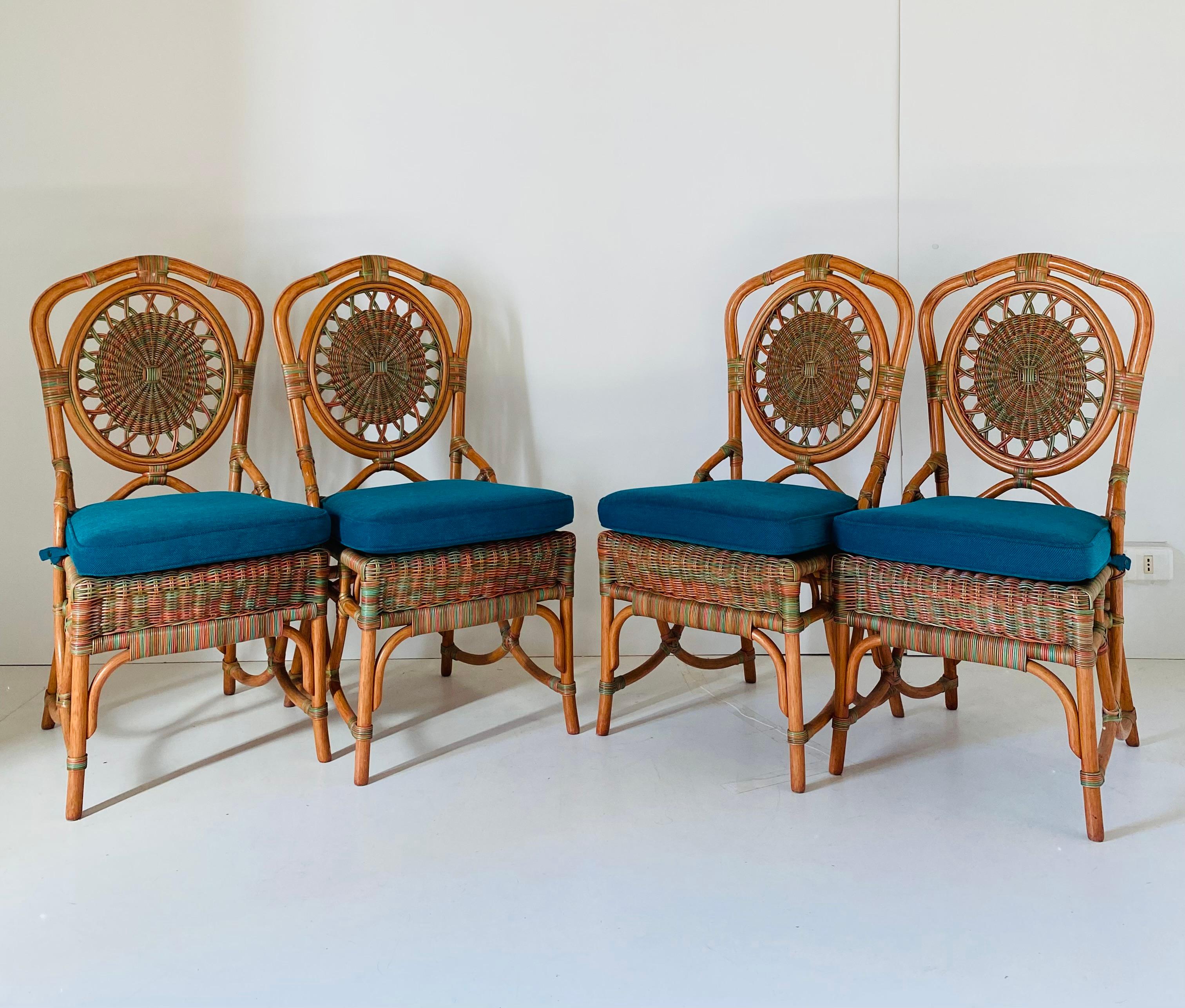 Beautiful set of four vintage chairs with rattan structure and confortable fabric pillow on the seat. Nicely decored dining chairs set with strong and elegant curved rattan structure. 1960s piece of design in pure colonial style. In really good