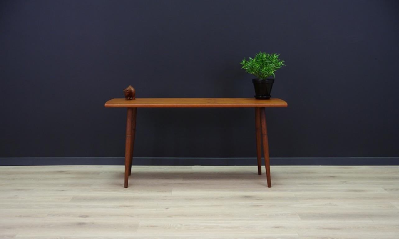 Neat table from the 1960s-1970s, Danish design, top covered with teak veneer, legs made of solid teak. Preserved in good condition (minor scratches) - directly for use.

Dimensions: Height 53 cm, tabletop 113.5 cm x 49.5 cm.