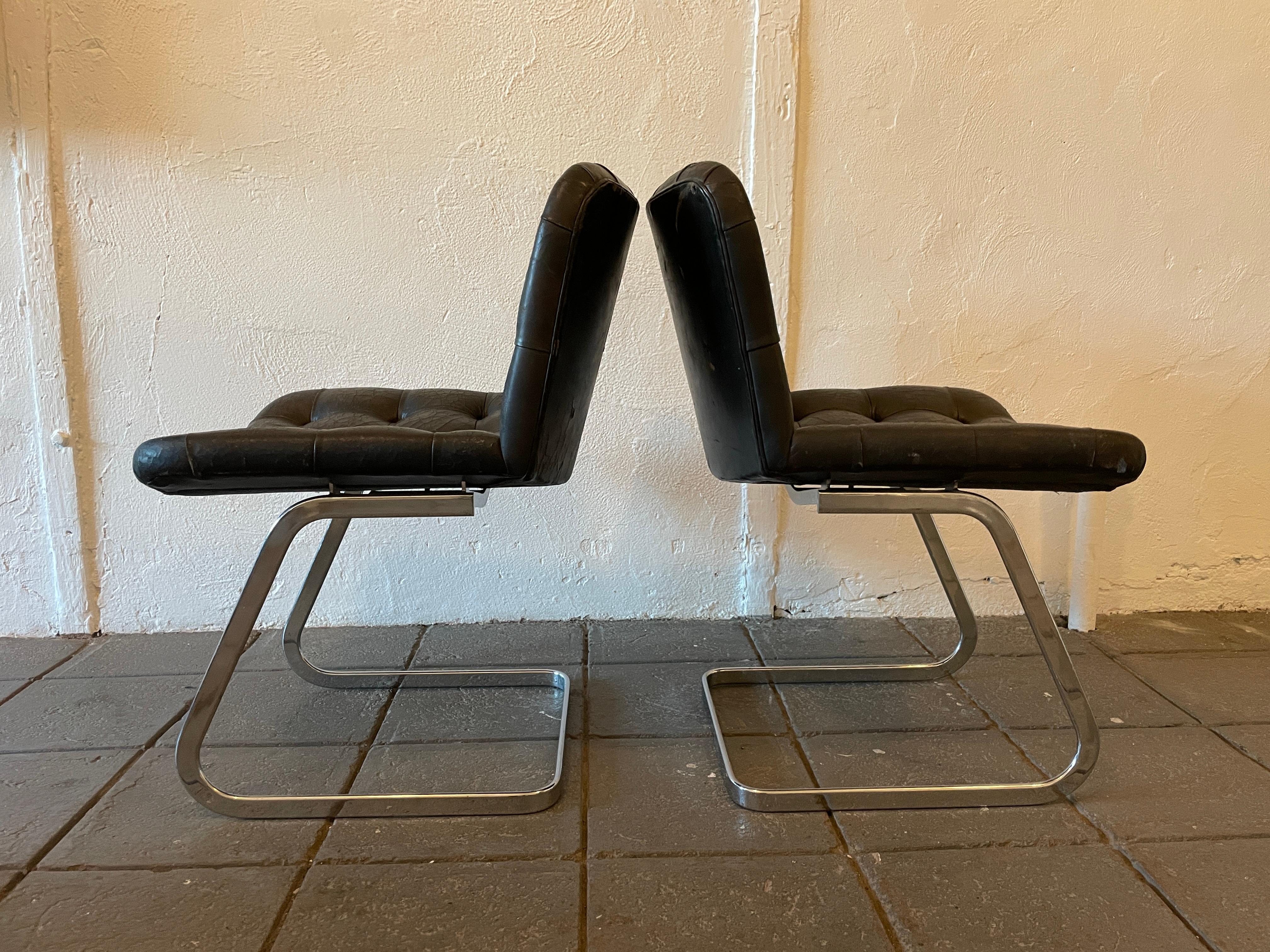 A unique set of (2) RH-304 leather chairs
designed by Robert Haussmann and manufactured by Stendig / de sede. This set is hand built in the 1960s, these chairs are upholstered in black leather with some cracks. The frames are made of chrome-plated