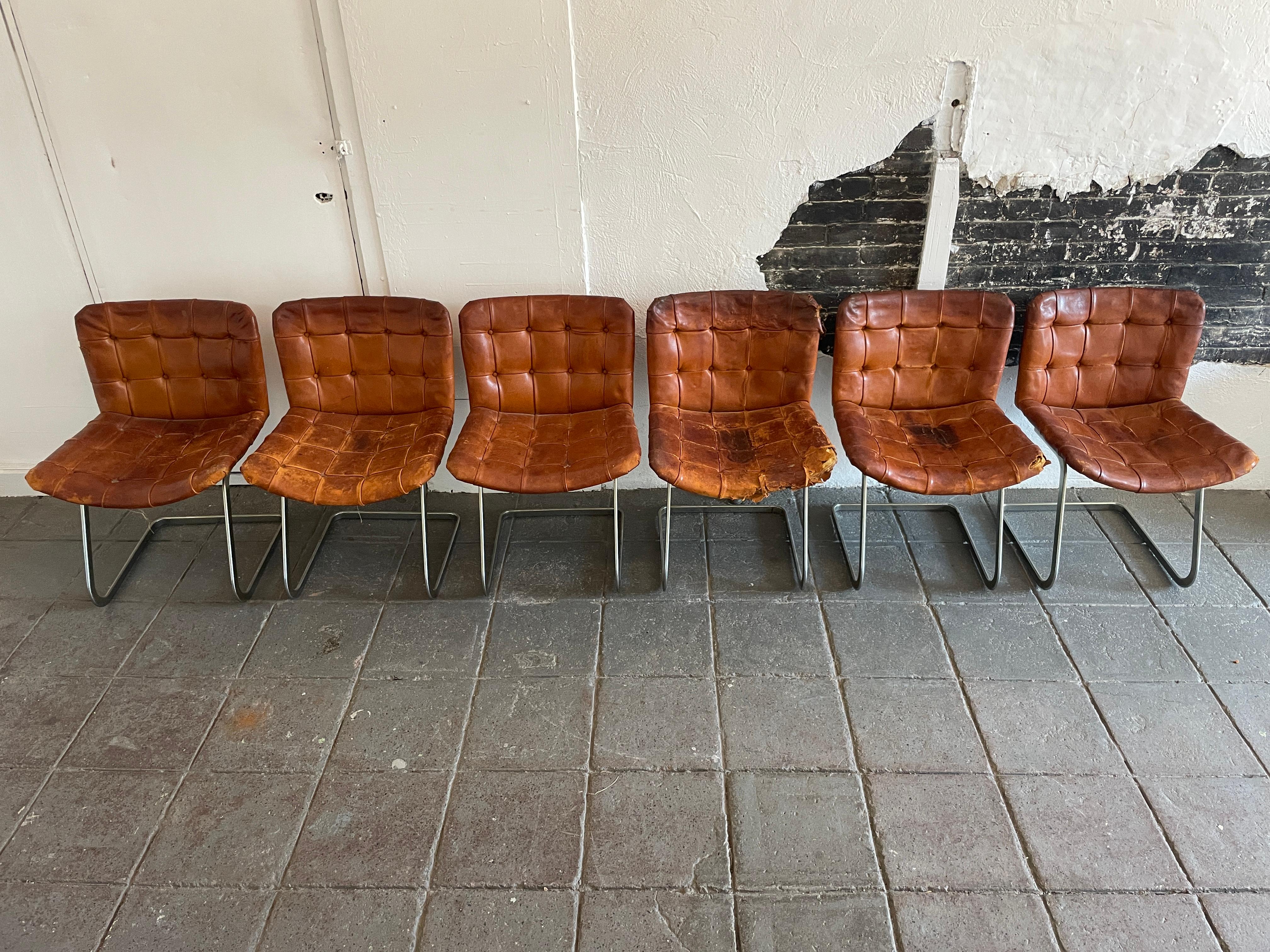 A unique set of six RH-304 leather chairs
designed by Robert Haussmann and manufactured by Stendig / de sede. This set is hand built in the 1960s, these chairs are upholstered in saddle brown leather with some tears. The frames are made of