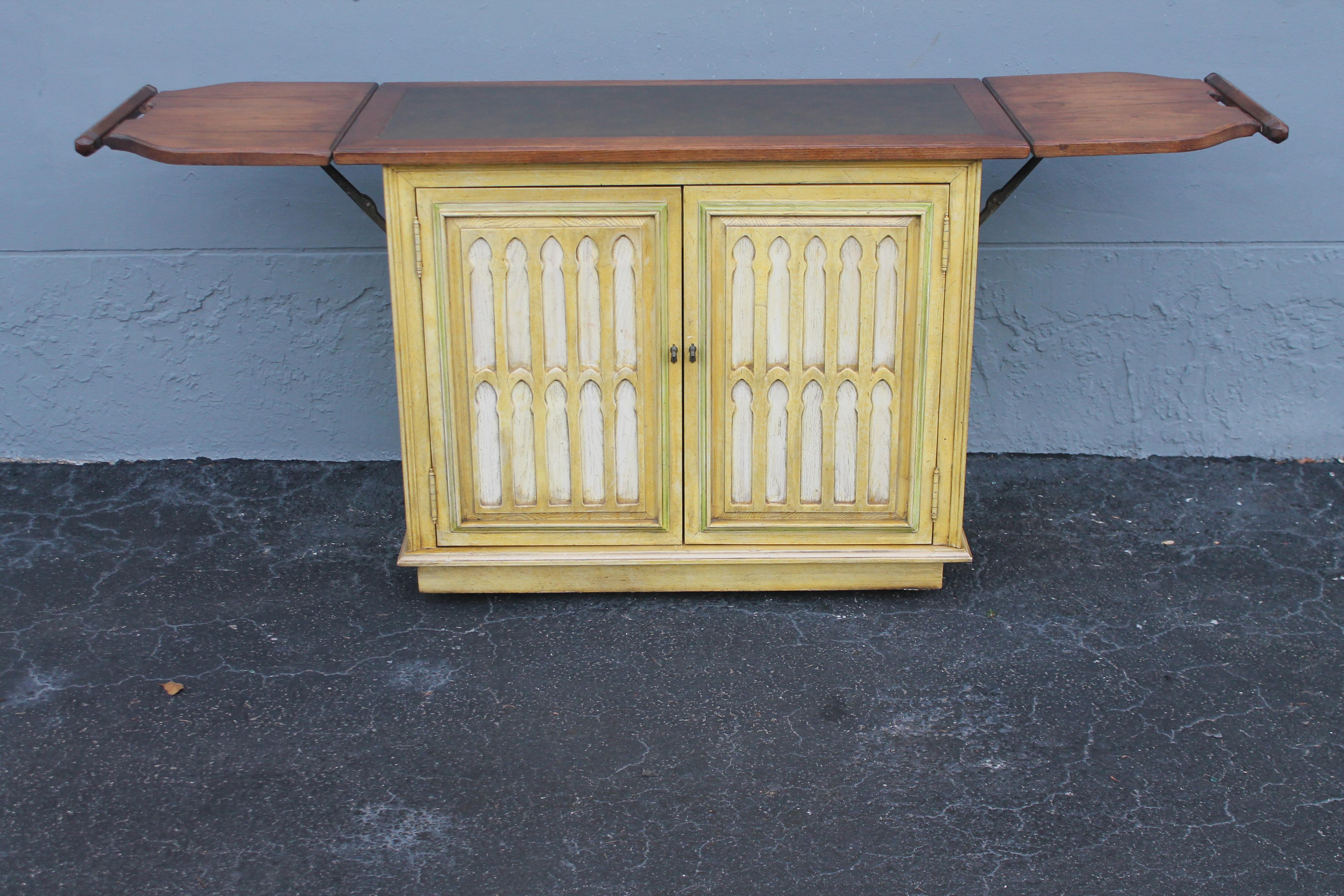 Vintage Rolling Dry Bar/ Cabinet. The dry bar has flaps on both side which when raised make the length 71