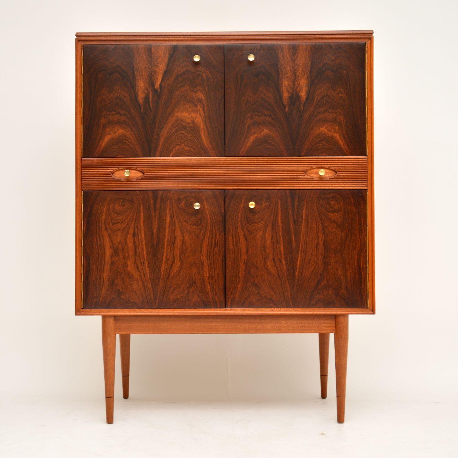 A stunning vintage drinks cabinet, designed by Robert Heritage for Archie Shine. This is part of the award winning Hamilton range, and it dates from the 1960s. The doors are in rosewood, with stunning grain patterns and a beautiful color. The