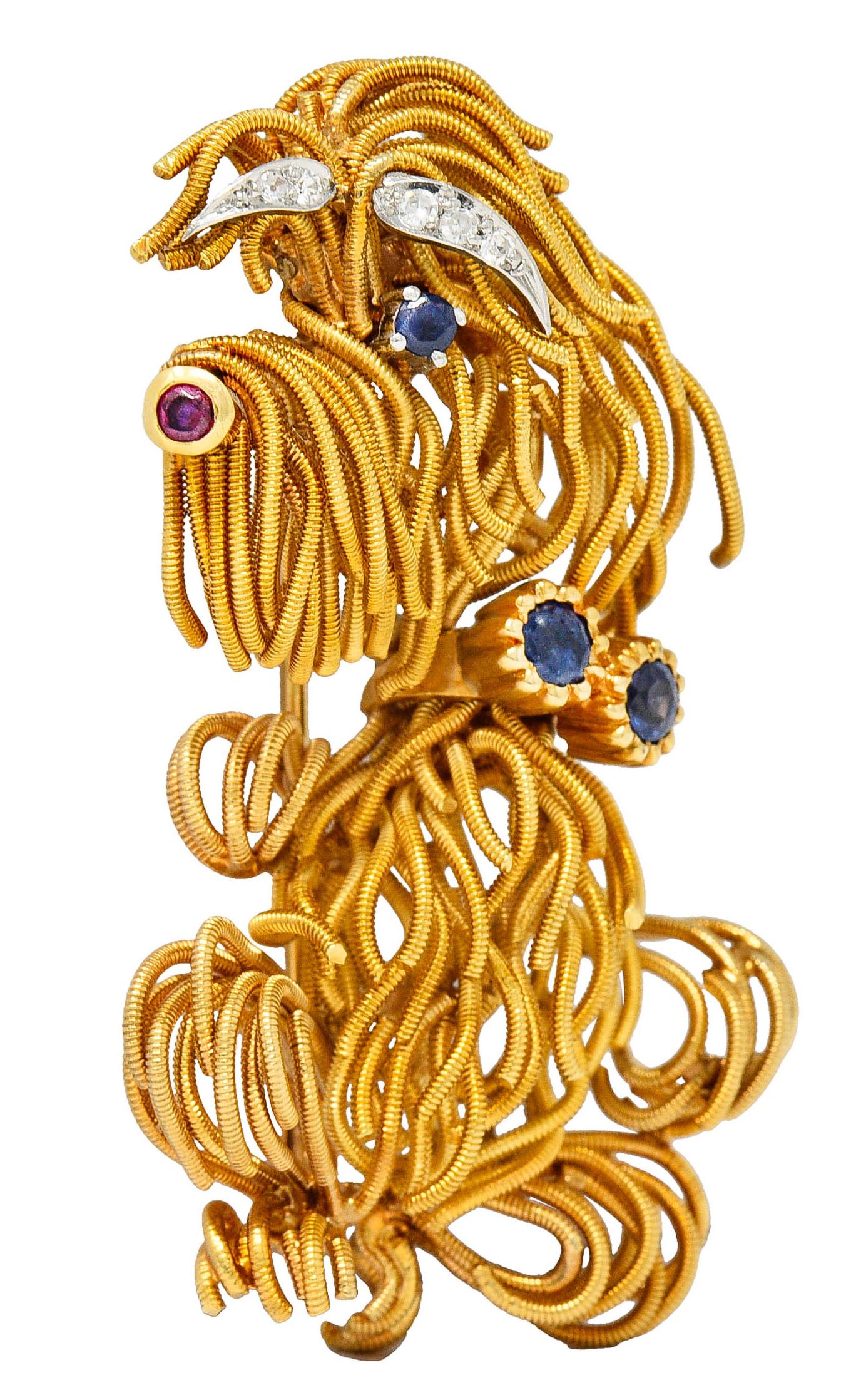 Brooch is designed as a whimsically styled Maltese dog comprised of coiling gold tendrils

With platinum eyebrows accented by single cut diamonds weighing approximately 0.10 carat - eye clean and white

Nose is bezel set with a purplish red ruby