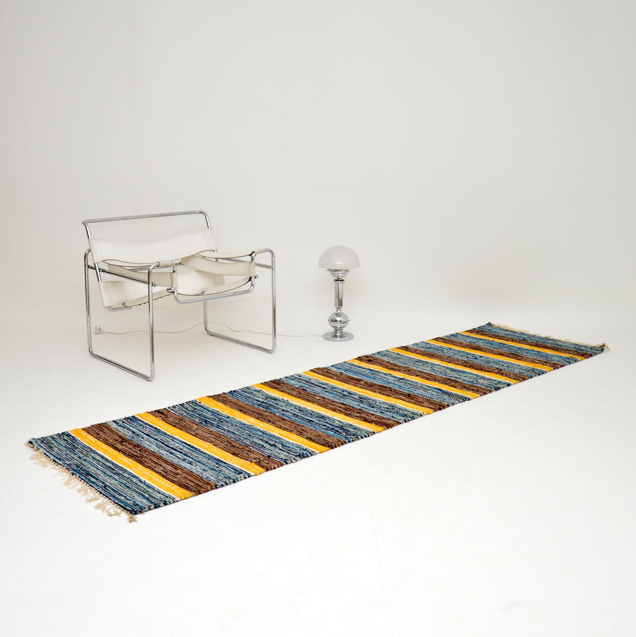 A beautiful vintage rug, this was made in Finland in the 1960s. It is very long and narrow, perfect for an entry or passage way. It’s woven from high quality wool and has many beautiful colors. This is in very good condition, with just some minor