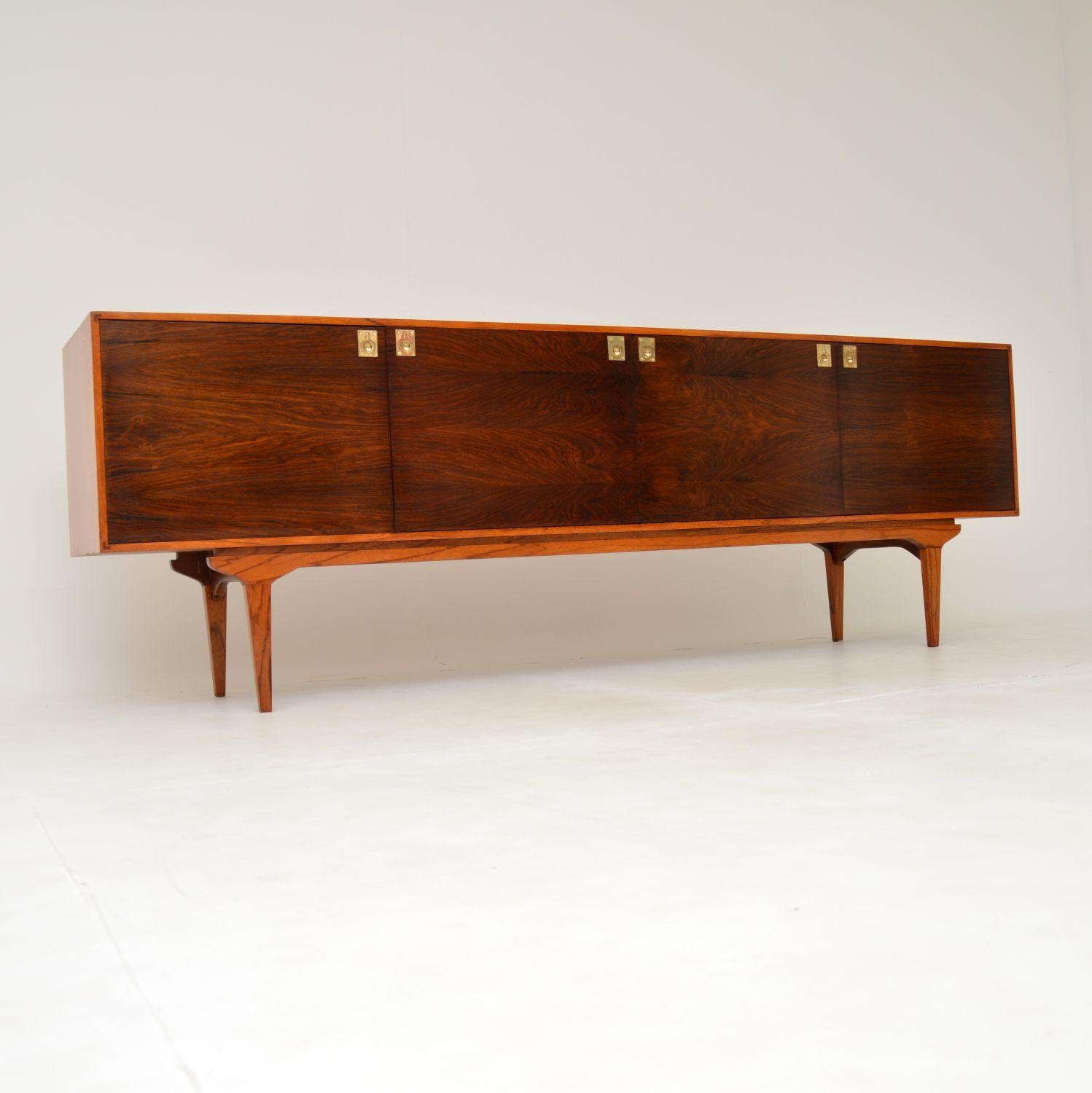 A stunning and extremely well made vintage sideboard. This was made in the UK by Everest furniture, it dates from the 1960’s.
These were originally retailed in Heal’s in the 1960’s, the quality and design is of the highest order. The front has a