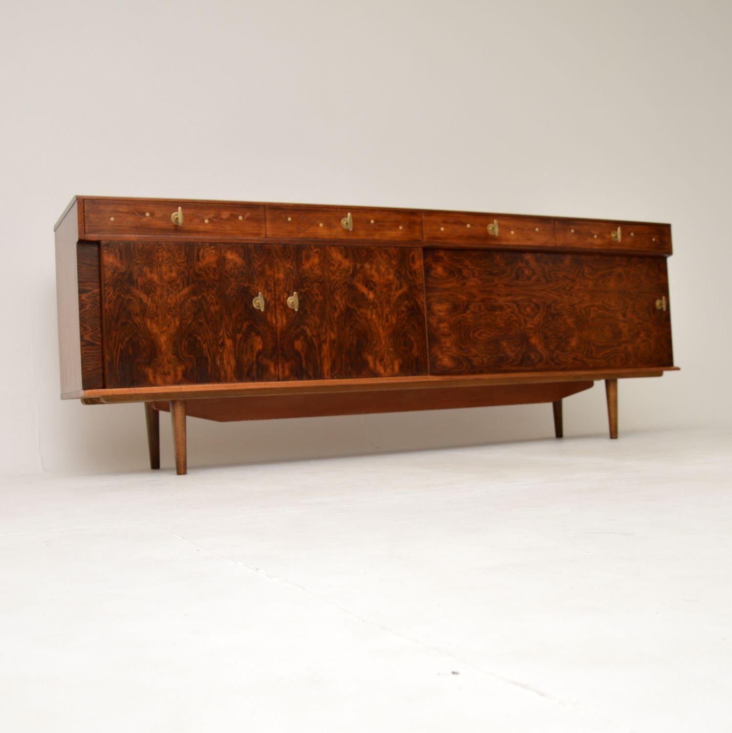 An absolutely stunning and extremely rare sideboard. This was made in England by Everest, it dates from the 1960’s. It was most likely designed by Andrew Milne, he was known to have worked with Everest around this period and it certainly has the