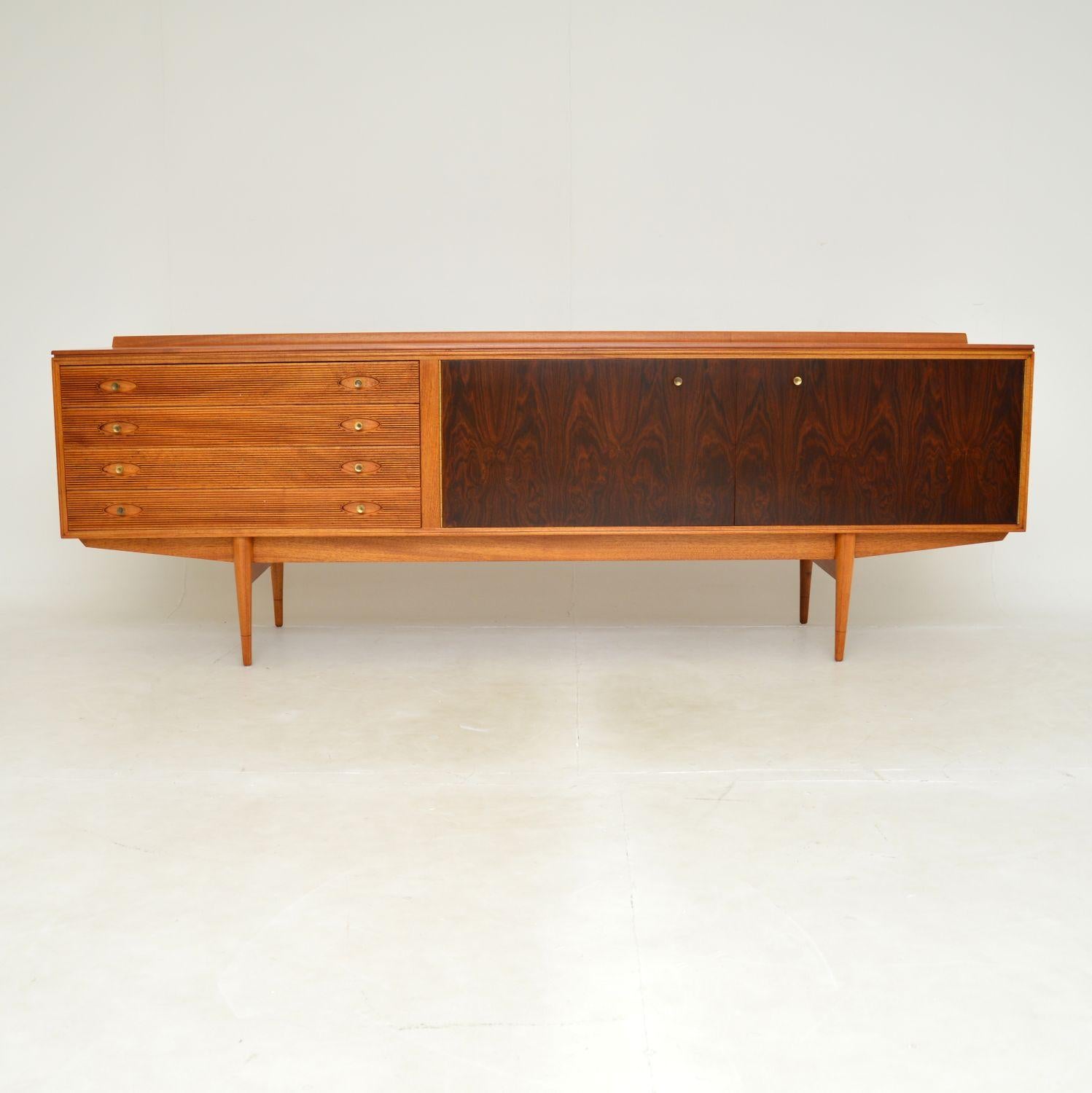 A superb vintage ‘Hamilton’ sideboard in wood and brass. This was designed by Robert Heritage for Archie Shine, it was made in England in the 1960’s.
The quality is outstanding and this won various design awards when it was released in the 1950’s.