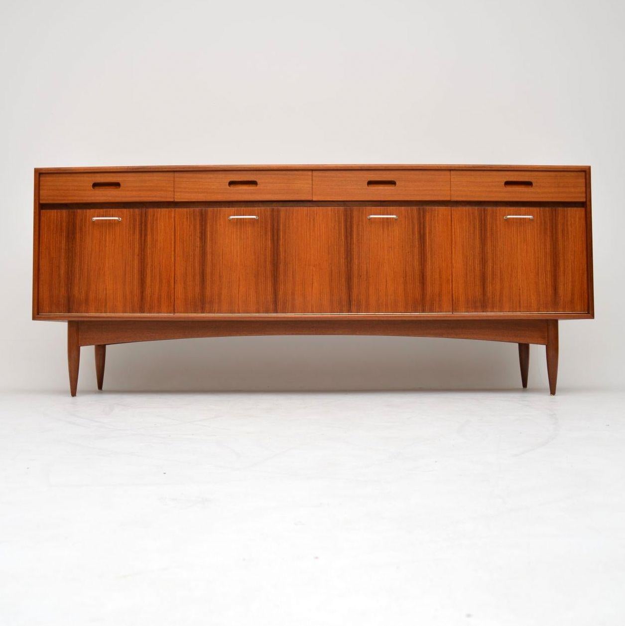A beautifully styled and extremely well made vintage sideboard from the 1960’s, this has wood doors with a walnut top and sides. It’s of super quality, with unusual brushed steel handles, it’s also nicely finished on the back, so can be used as a
