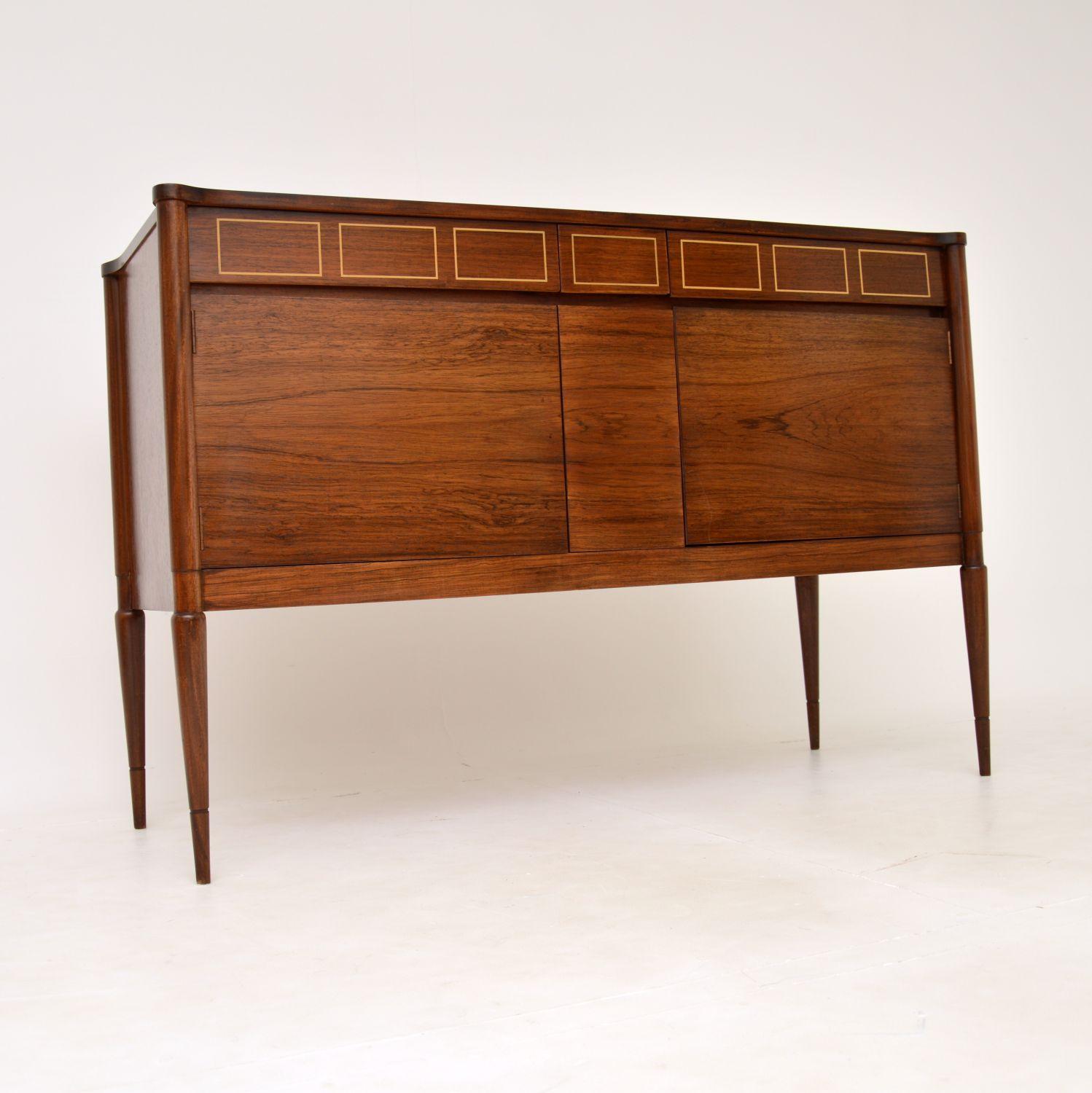 A beautiful and unique vintage sideboard. This was made in England in the 1960’s, the previous owner actually had it bespoke made especially for him.

It is of superb quality and is beautifully designed. It sits on lovely tapered legs and has an