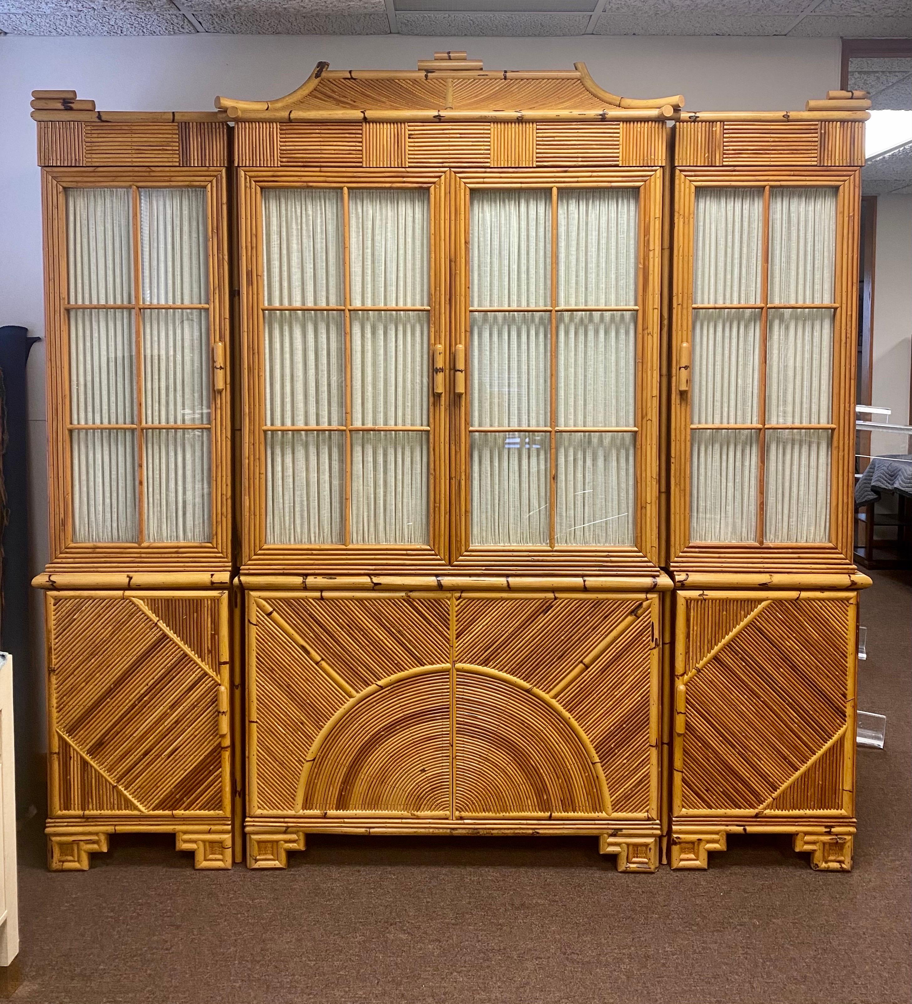 We are very pleased to offer a one-of-a-kind display cabinet, circa the 1960s. Framed in solid wood, this beautiful piece showcases exquisite craftsmanship at its finest, hand-applied split reed bamboo wraps the entire unit; the result, an organic