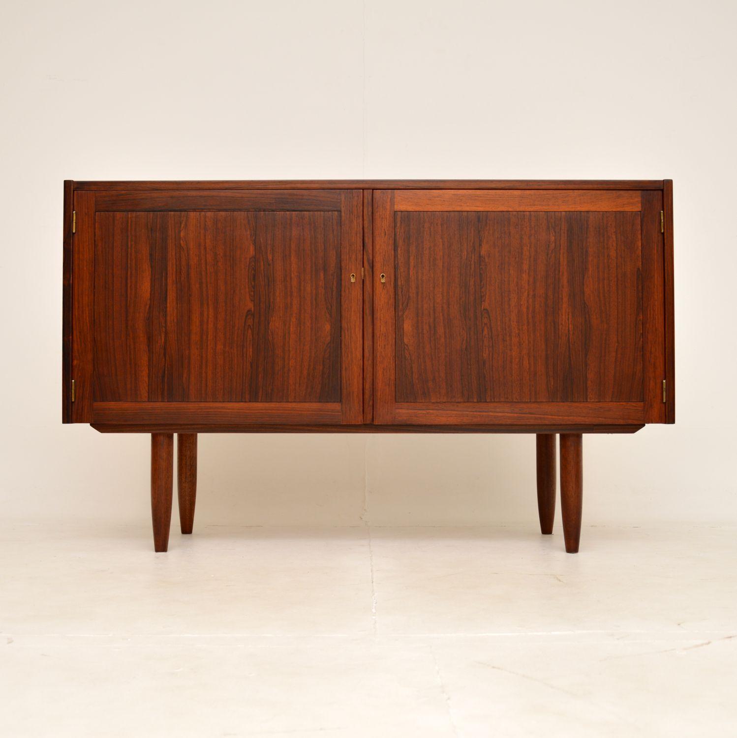 A very stylish and well made vintage sideboard. This was made in Sweden, it was designed by Nils Jonsson and made by Troeds.

It is of lovely quality, with beautiful grain patterns and a gorgeous colour tone. The interior is lined with