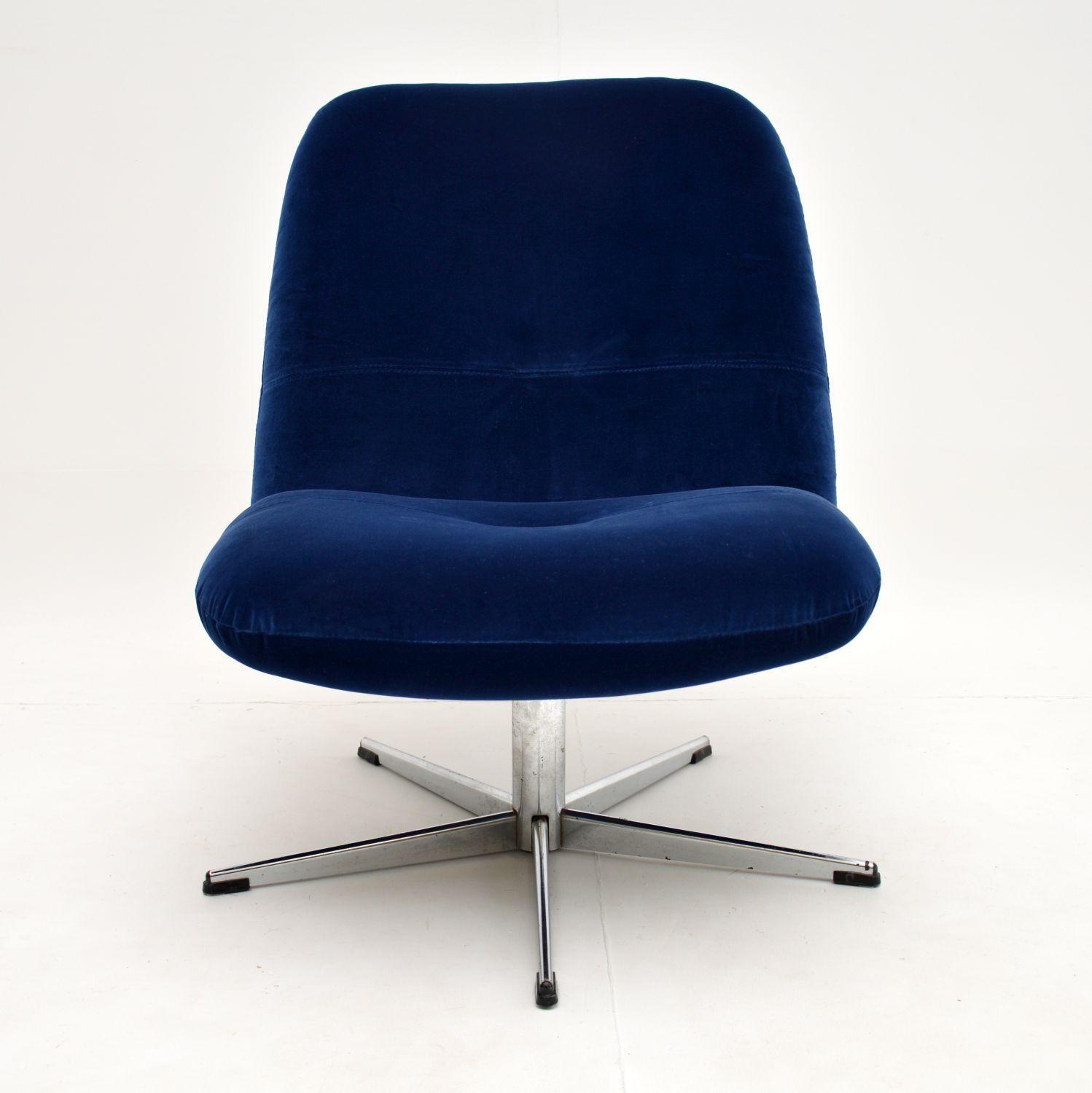 A sweet and stylish vintage swivel lounge chair, this dates from the 1960s. It is very comfortable, it sits and swivels on a lovely five prong chrome base.

We have had this fully re-upholstered in a lovely blue velvet fabric, it is in excellent