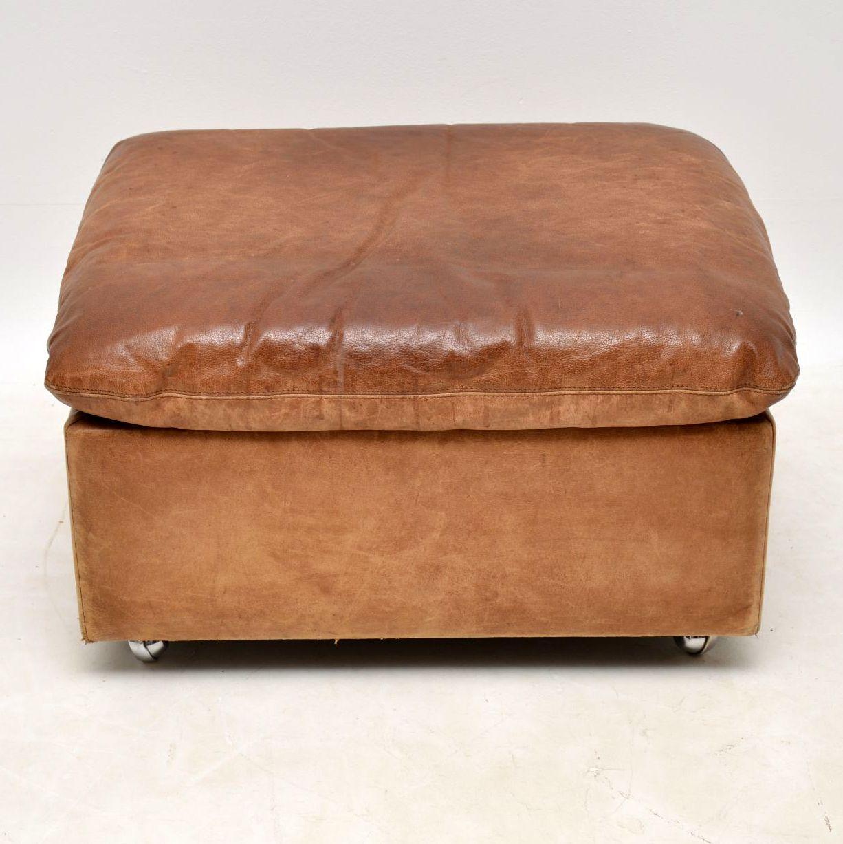 A beautiful and very well made vintage ottoman in high quality tanned leather, sitting on chrome casters. It dates from around the 1960s-1970s, and is in lovely vintage condition; the leather is thick and strong, with no rips or tears. This has