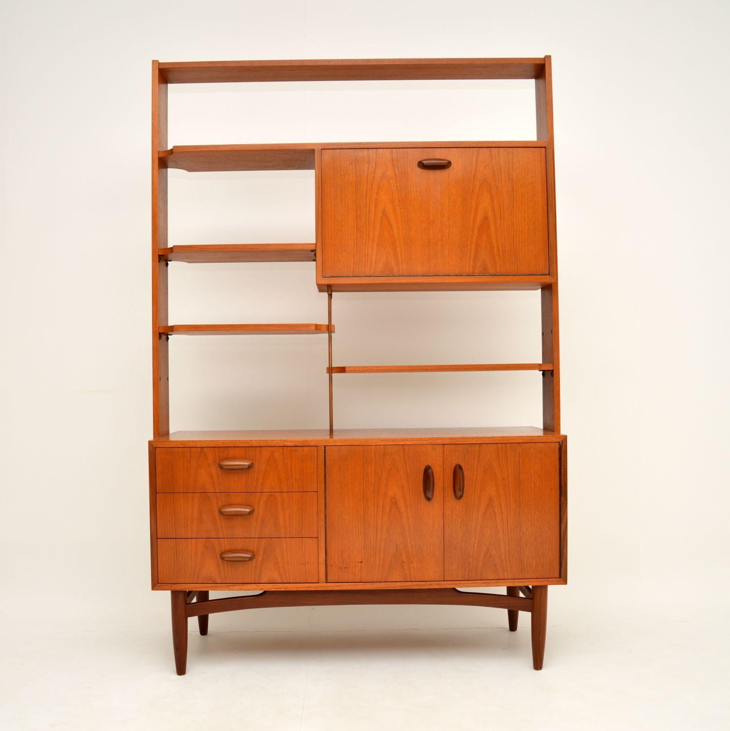 A stylish, top quality and very useful teak vintage bookcase / cabinet by G- Plan, dating from the 1960s. This is perfect for use as a wall unit or a room divider, as the back is beautifully finished as well.

The shelves are adjustable, and this