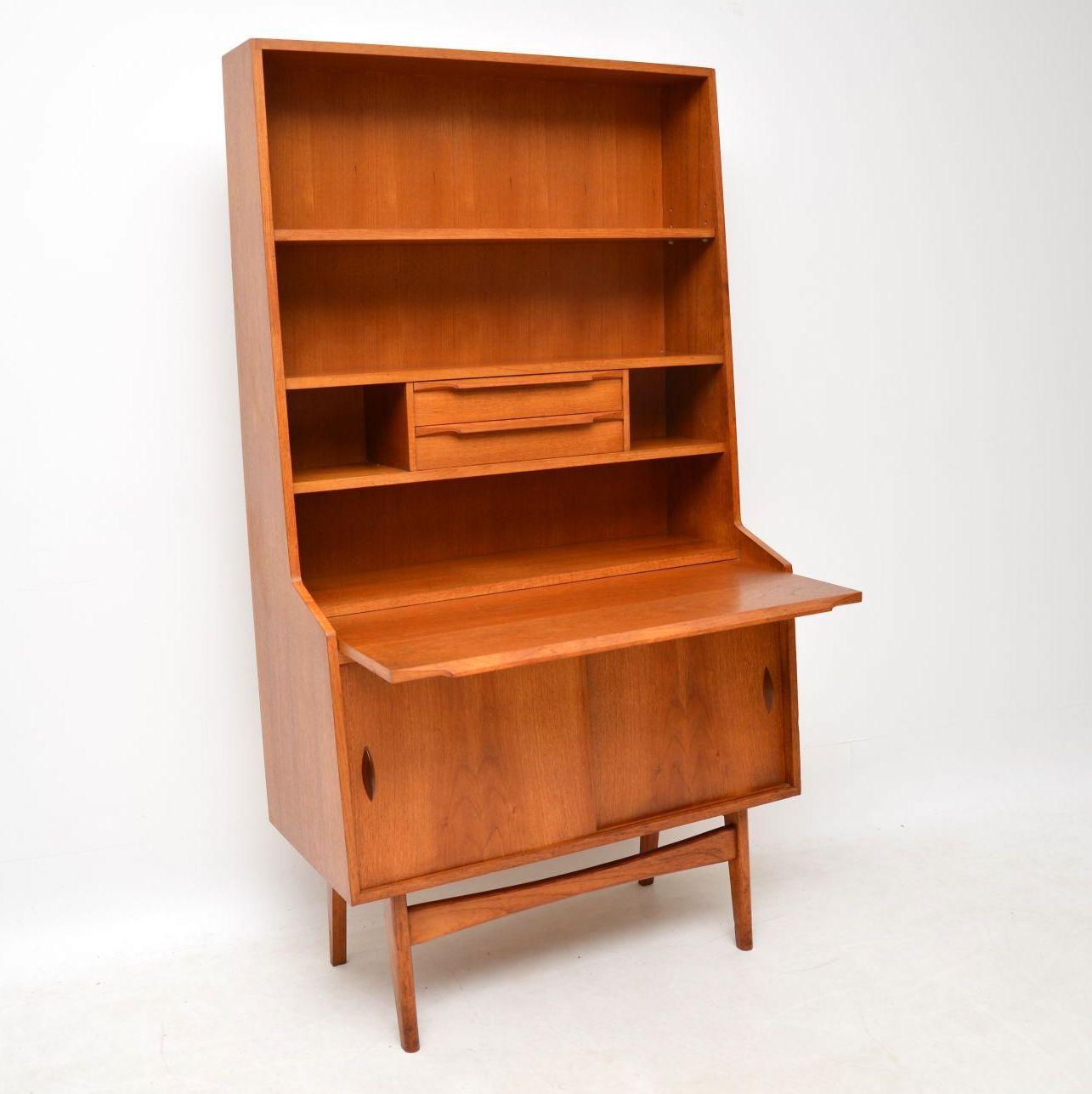 A smart, stylish and very useful bureau bookcase in teak, this dates from the 1960s. It’s extremely well made and beautifully designed, with lots of storage space and a handy pull out writing slide; everything you need in a work station. The