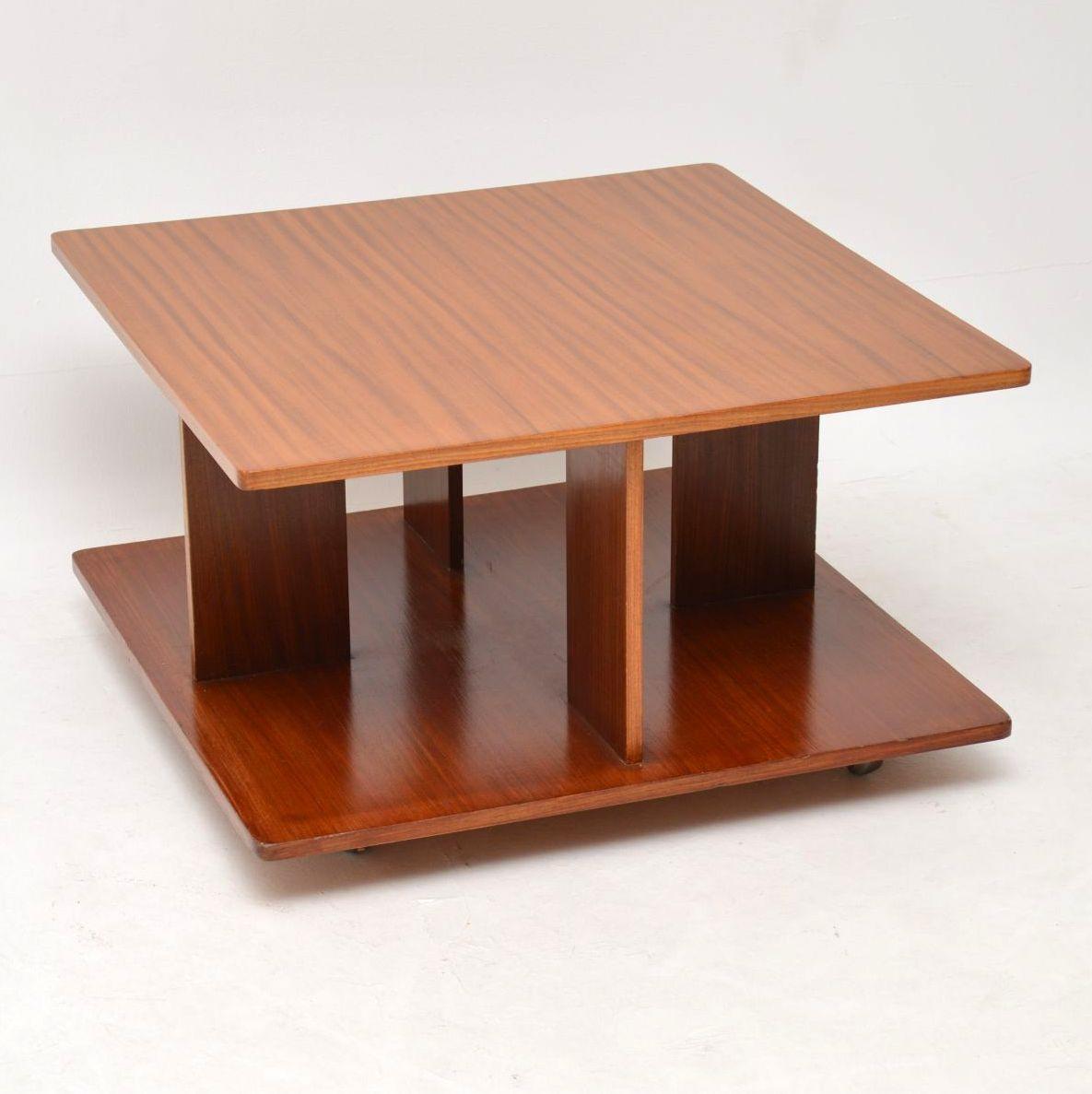 A beautifully designed and very rare vintage teak coffee table with four matching stools that tuck underneath the top. This dates from the 1960s and is in superb condition for its age. The table is clean, sturdy and sound, with barely any wear to be