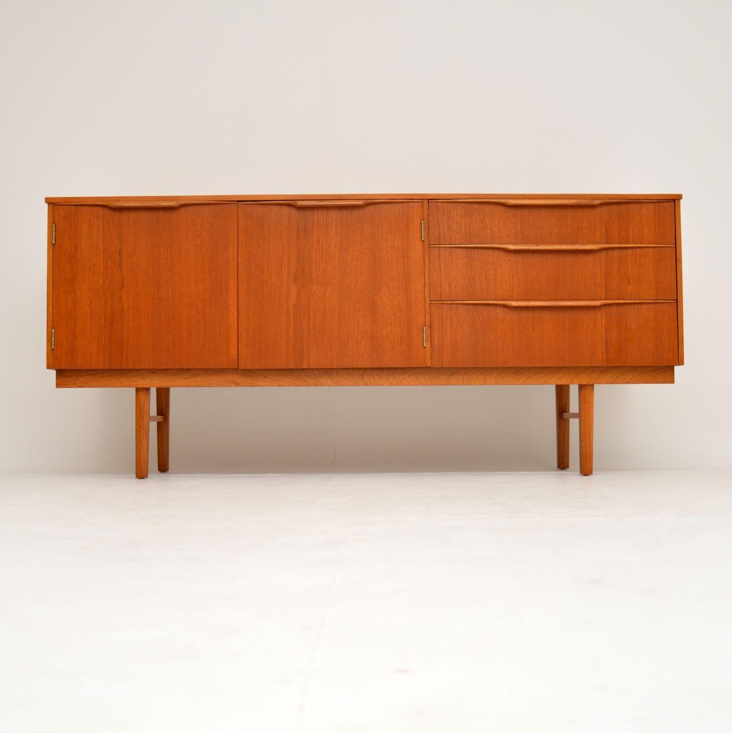 A smart, stylish and very well made vintage teak sideboard. This dates from the 1960s, and it’s in superb condition throughout. We have had it stripped and re-polished to a very high standard, it has a gorgeous color and lovely grain