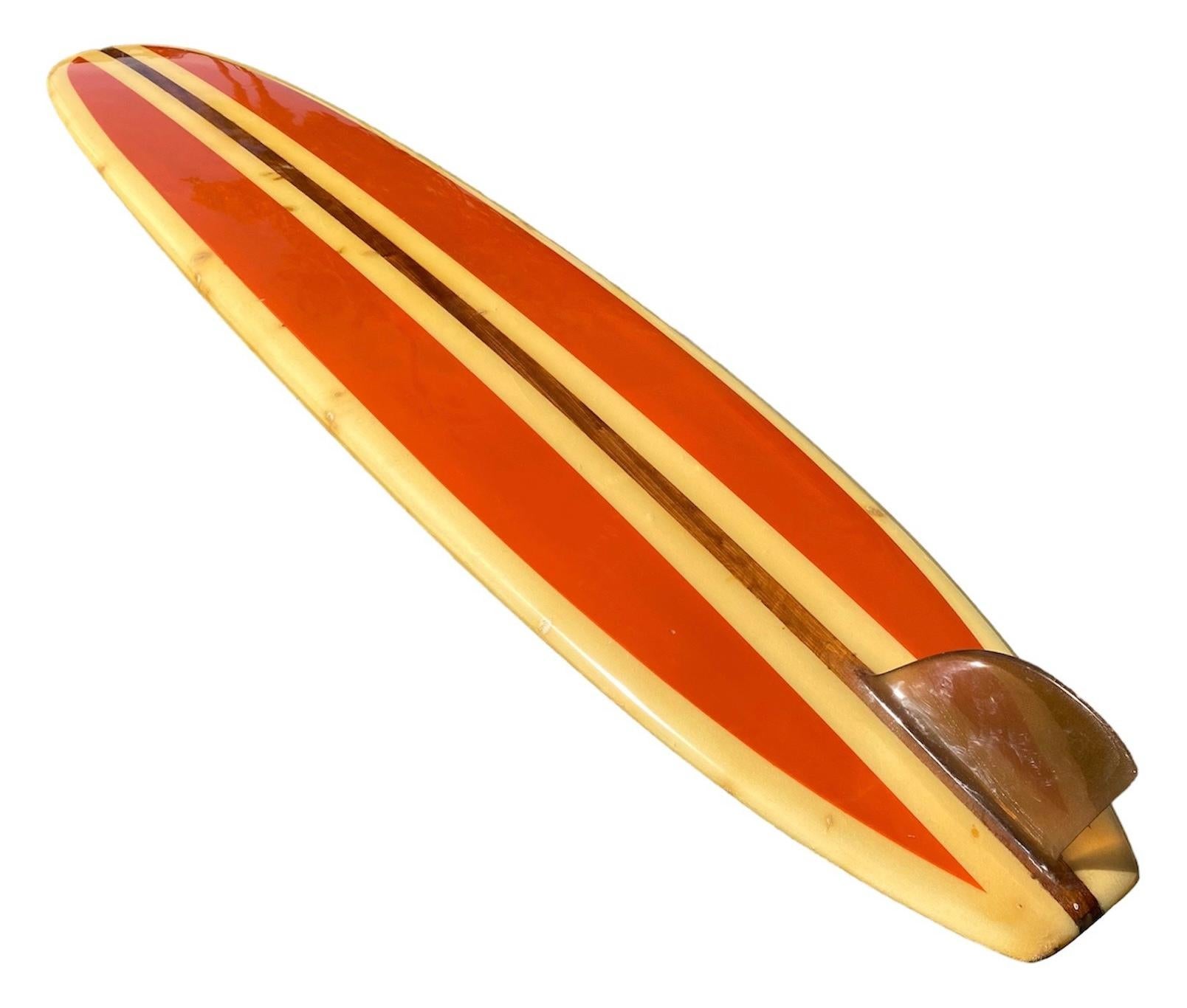 Early-1960s Vintage Ten Toes classic longboard. Features gorgeous orange pigment panels with redwood stringer and glassed-on fin. A remarkable example of a classic early 60s longboard in all original condition.